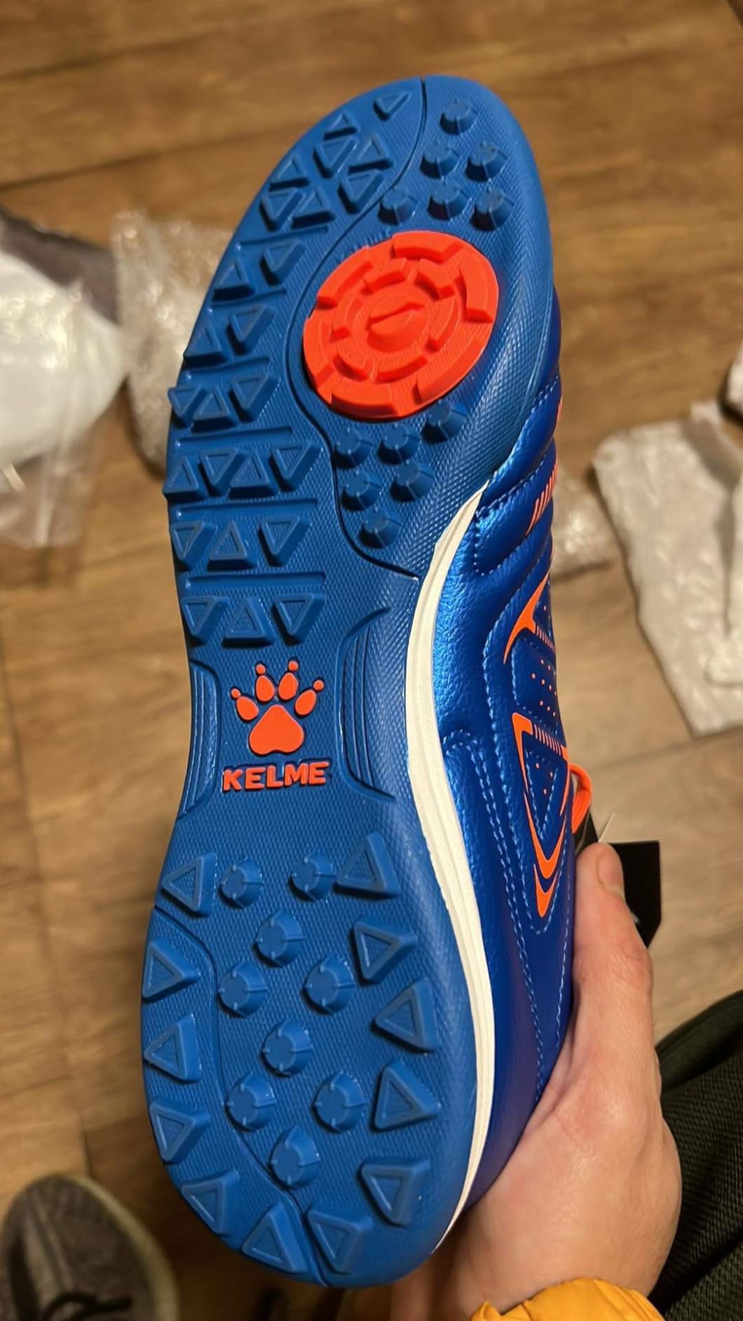 KELME cleats in action on indoor turf surface showing traction and movement during recreational soccer play