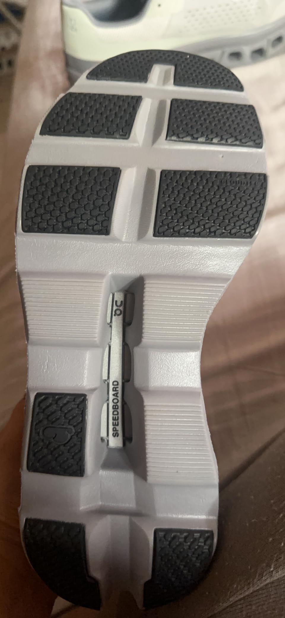 On Cloudmonster showing wear patterns after extended testing miles