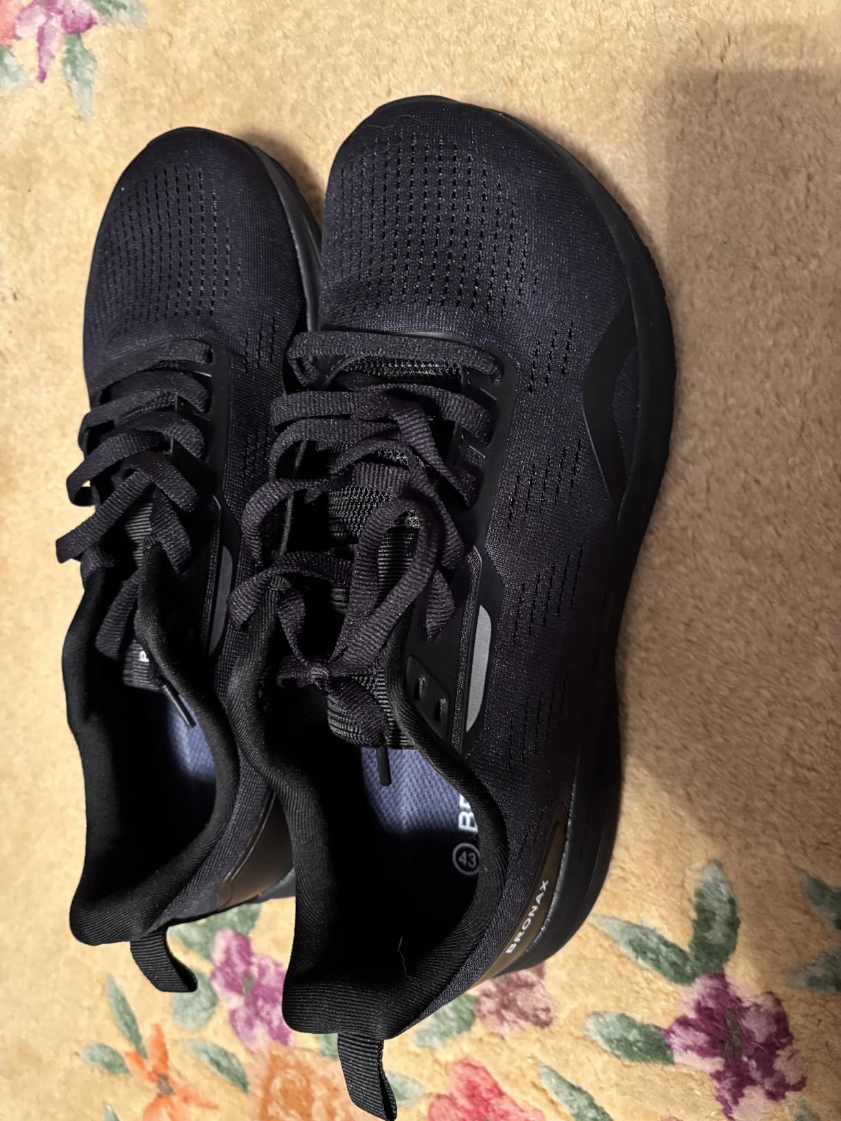 Side view of BRONAX running shoe showing mesh construction and low-profile silhouette