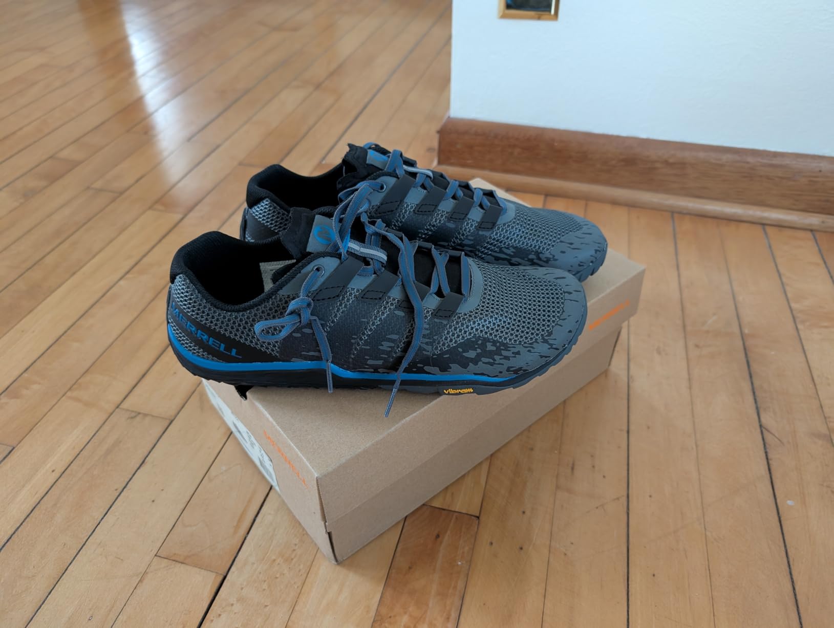 Merrell Men's Trail Glove 5 black colorway showing minimalist design and Vibram sole