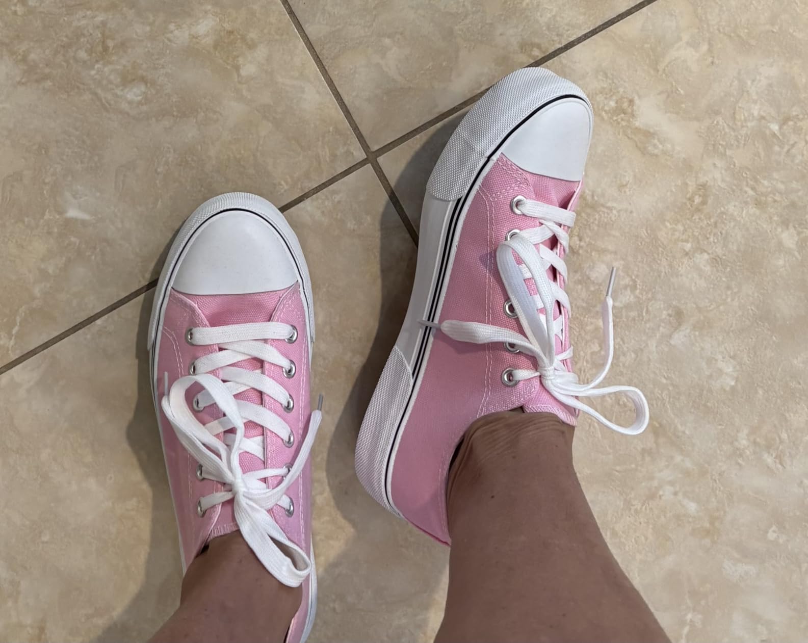 Bottom sole view of Adokoo sneakers showing tread pattern and rubber grip texture
