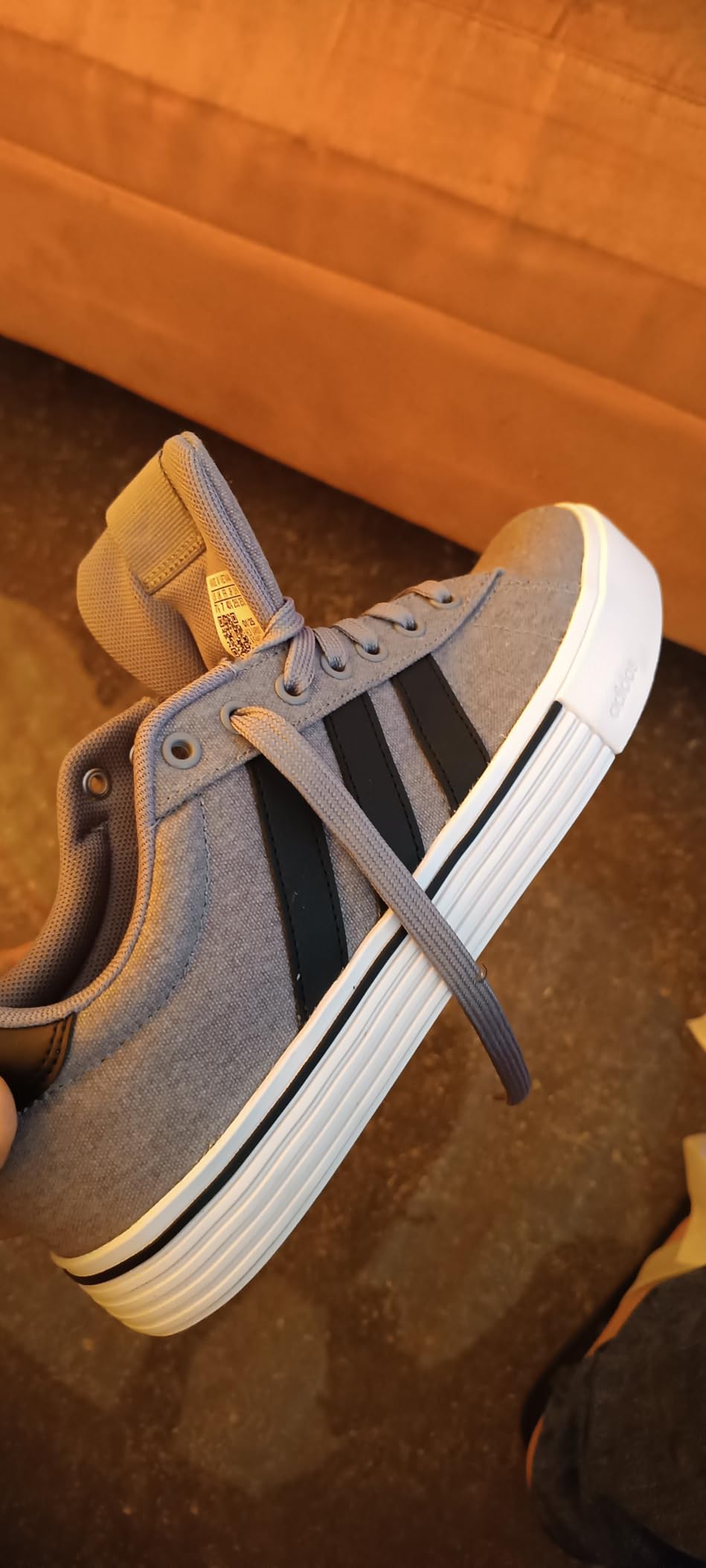 Adidas Daily 4.0 sneakers in grey black white colorway showing classic three stripes design