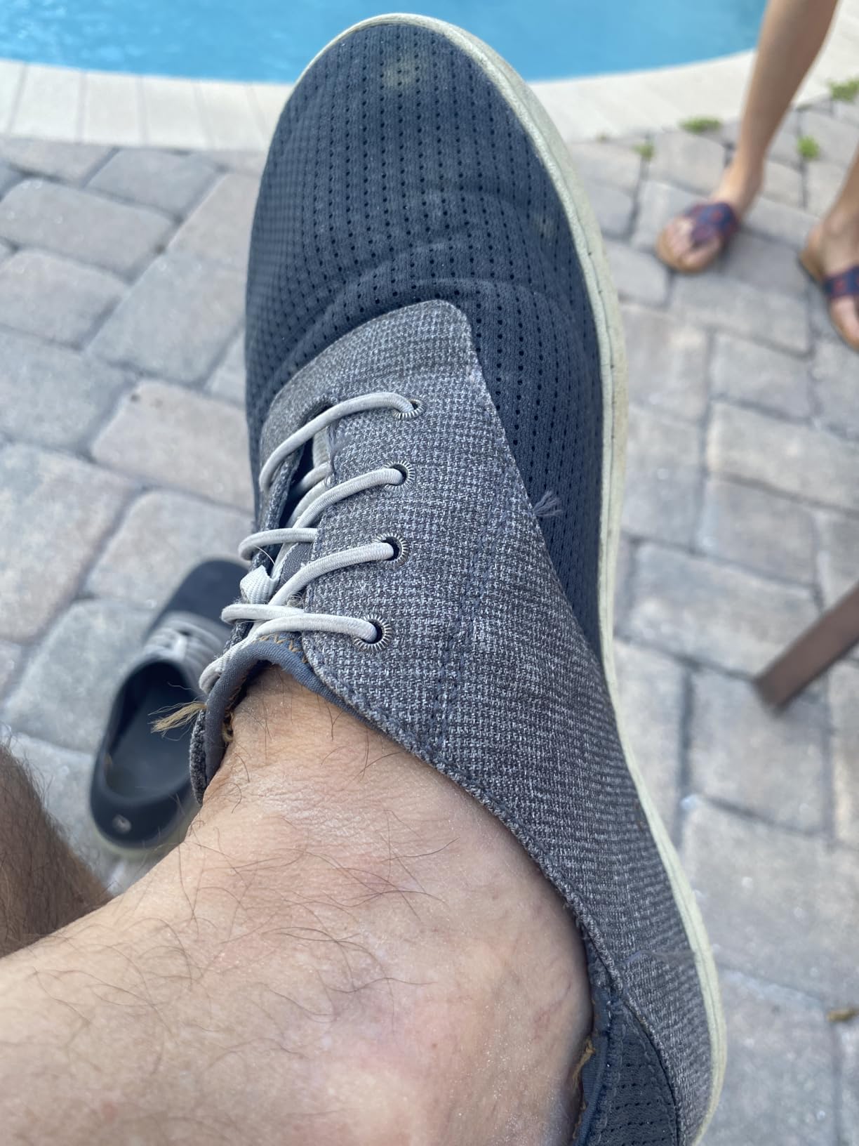 OLUKAI Nohea Moku Men's Boat Shoes in charcoal clay colorway showing elastic no-tie laces and breathable mesh upper