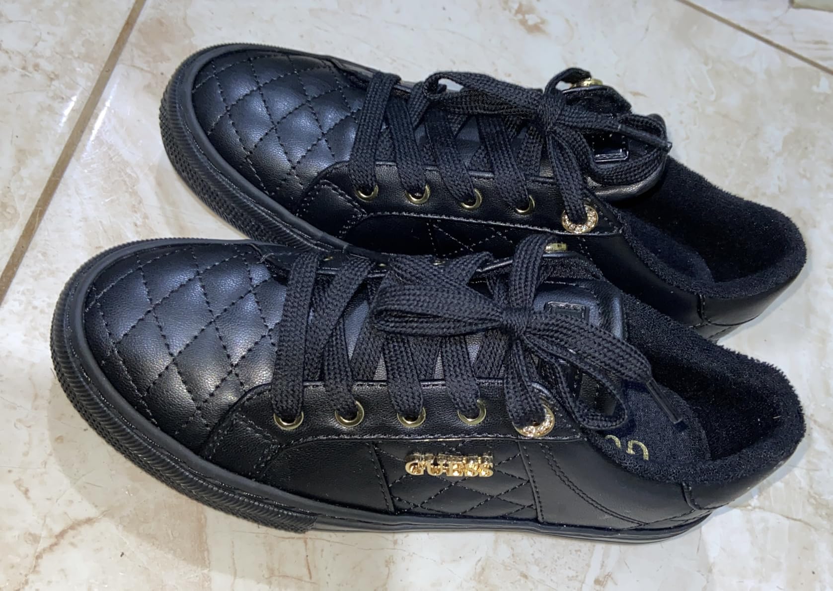 GUESS Women's Loven Sneaker interior showing cushioned footbed and smooth fabric lining
