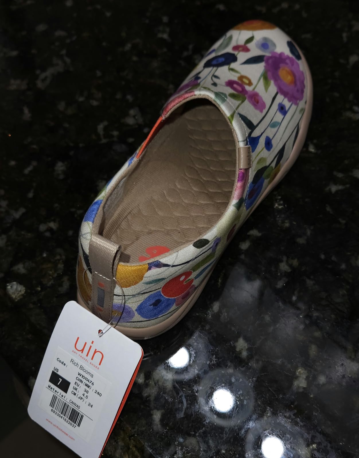 UIN Women's Blossom slip-on shoes showing vibrant hand-painted floral artwork on canvas with elastic side panel design