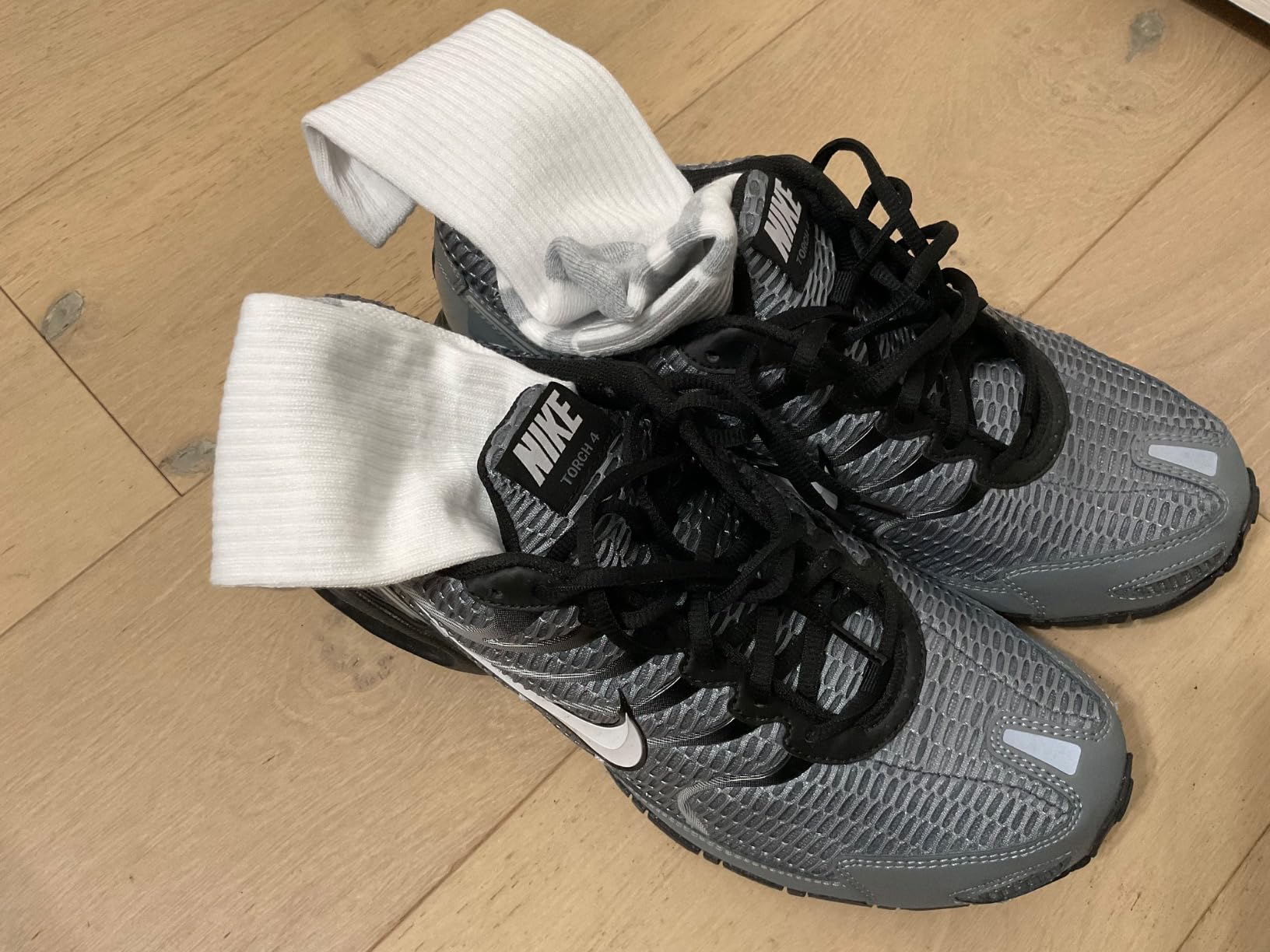 Nike Air Max Torch 4 detailed side view showing mesh construction and plastic cage