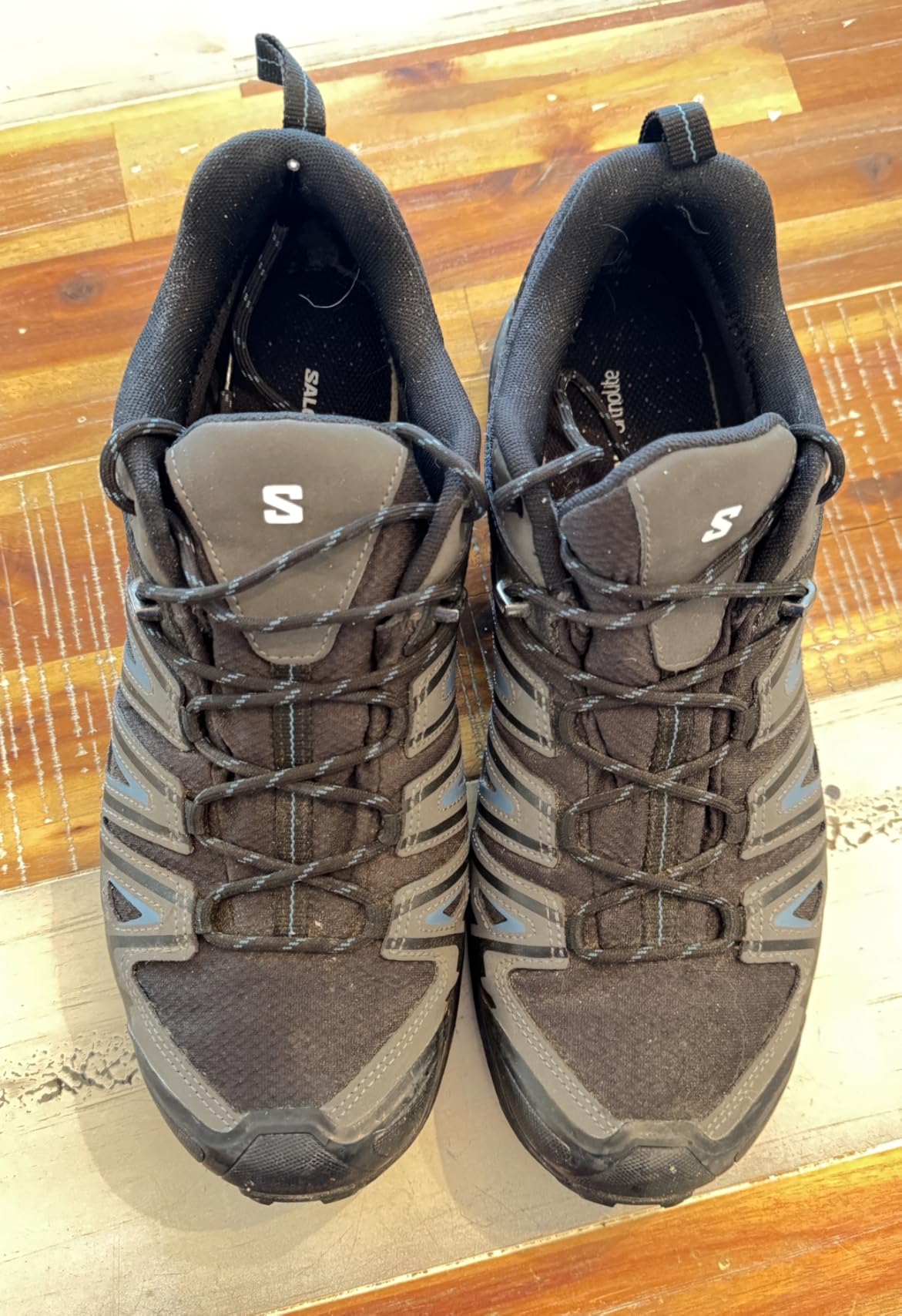 Multiple Salomon X Ultra Pioneer hiking shoes showing different wear patterns after real-world testing