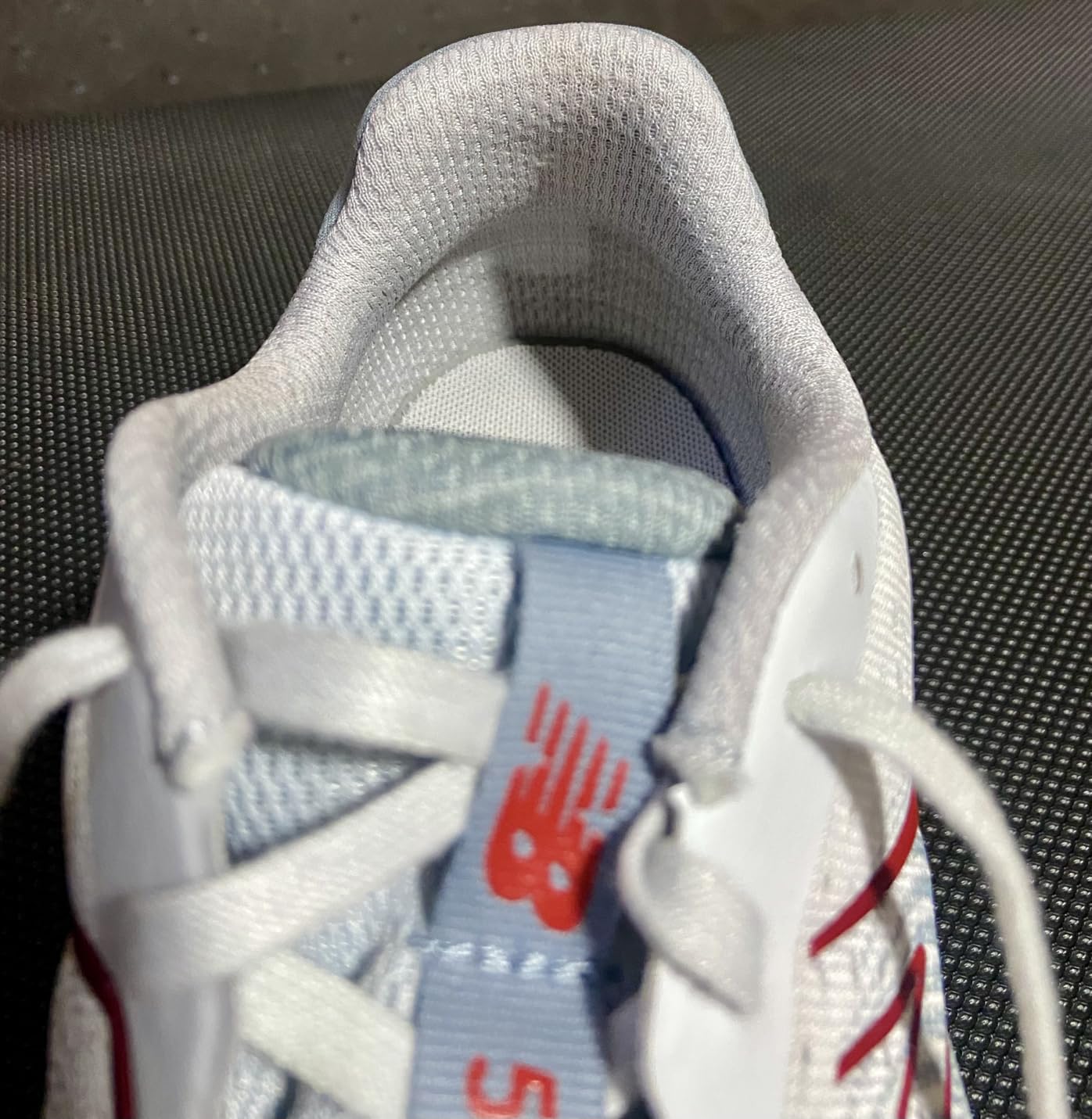 New Balance 520 V8 engineered mesh upper construction detail showing no-sew overlay design and breathable textile materials