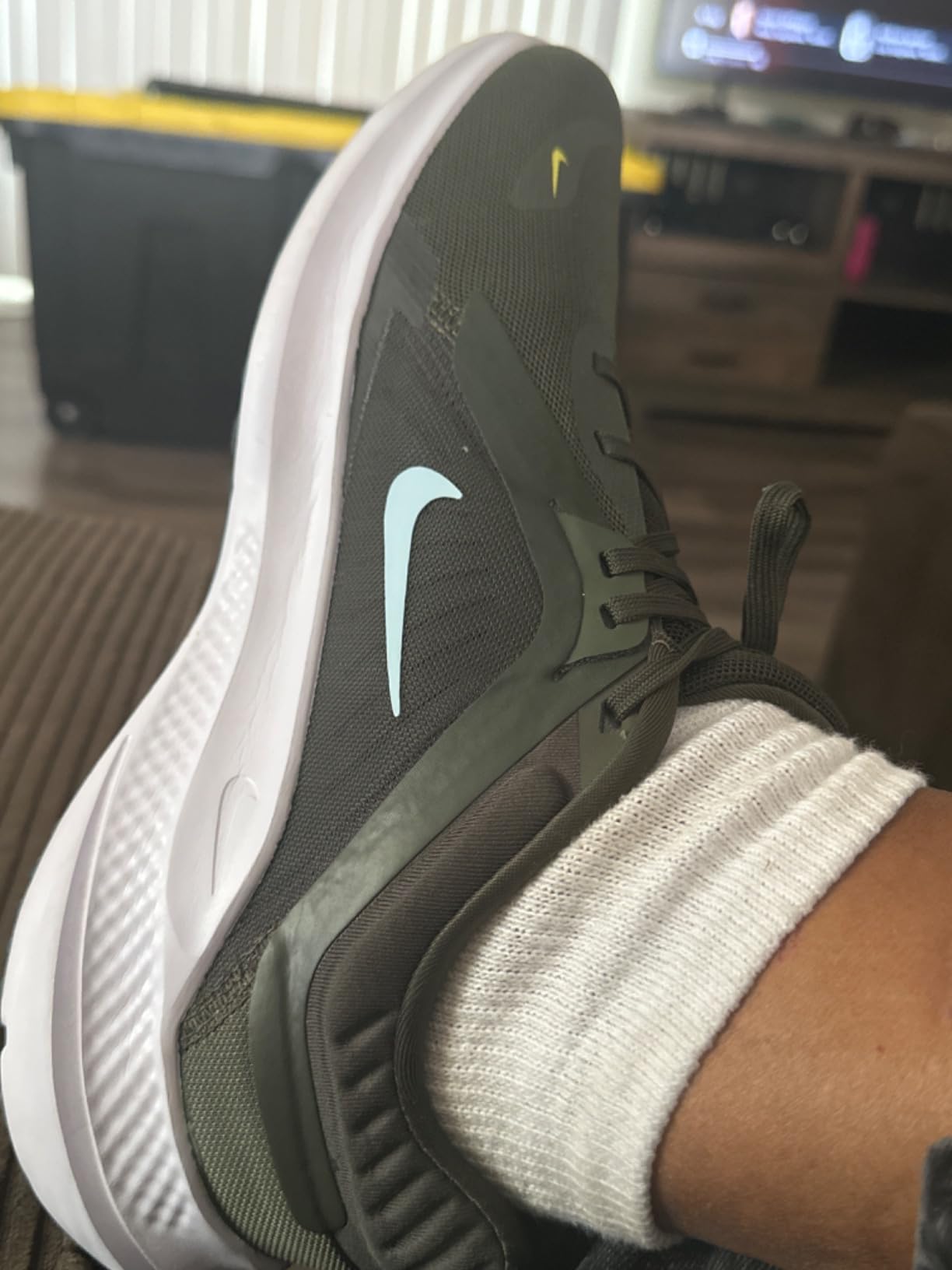 Nike Men's Quest 5 on foot during running session showing fit and midfoot lockdown in action