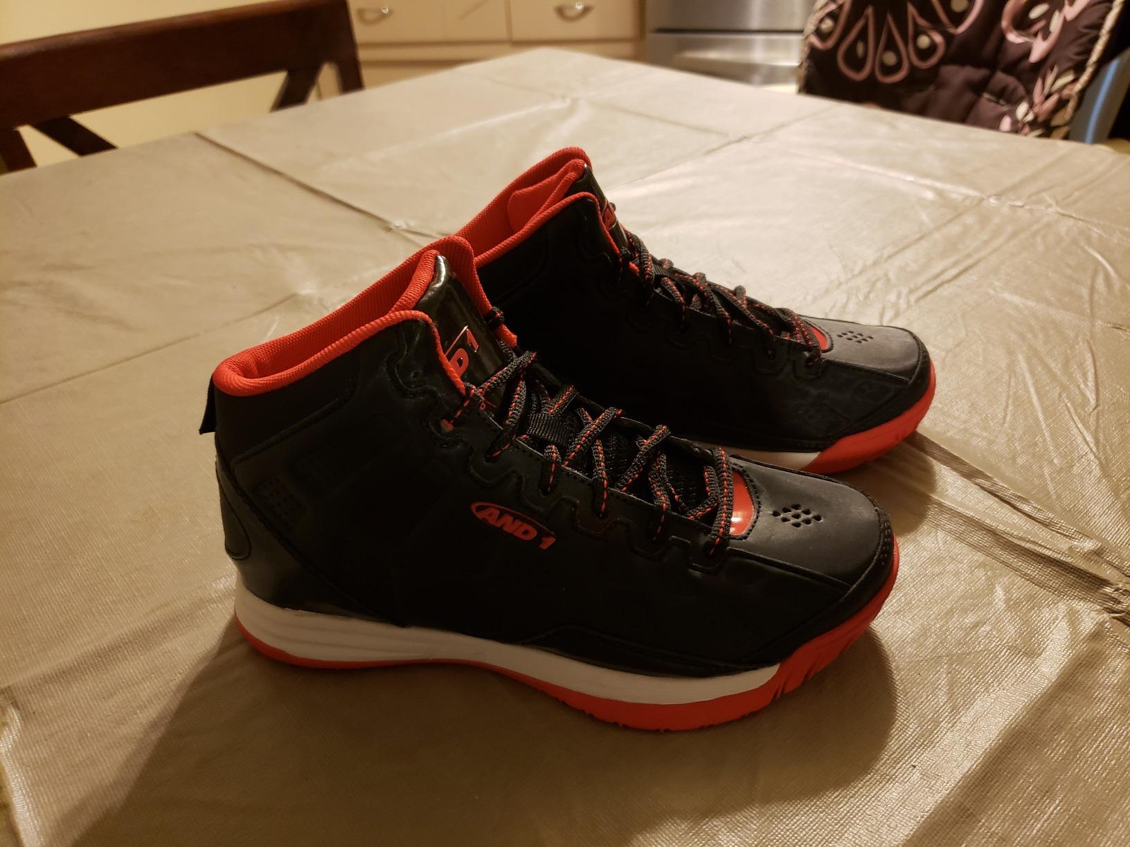 Child wearing AND1 Showout kids basketball shoes showing comfortable fit and happy expression during basketball play