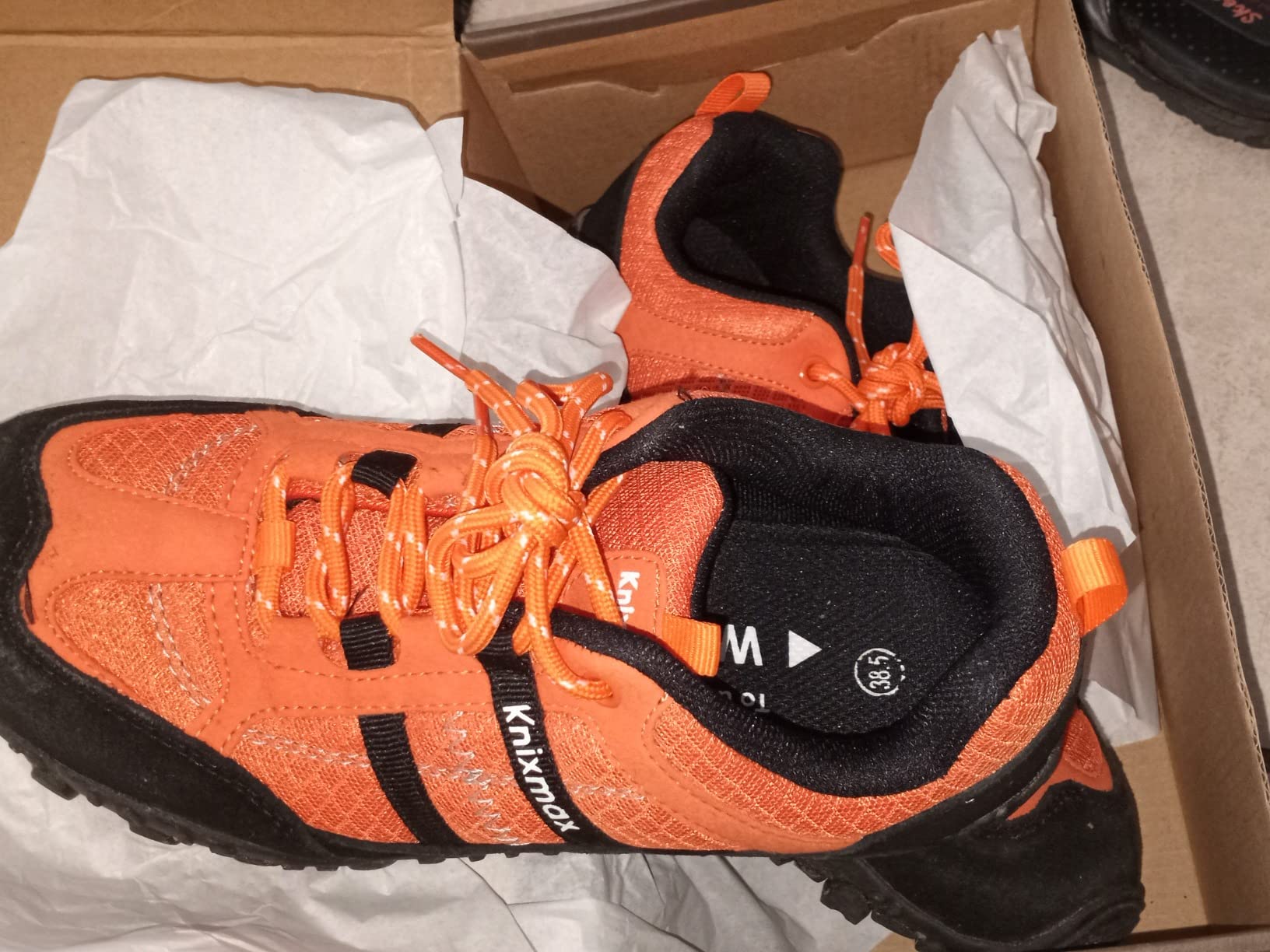 Knixmax hiking shoe packaging showing included extras: spare insoles, replacement laces, and the thoughtful unboxing experience
