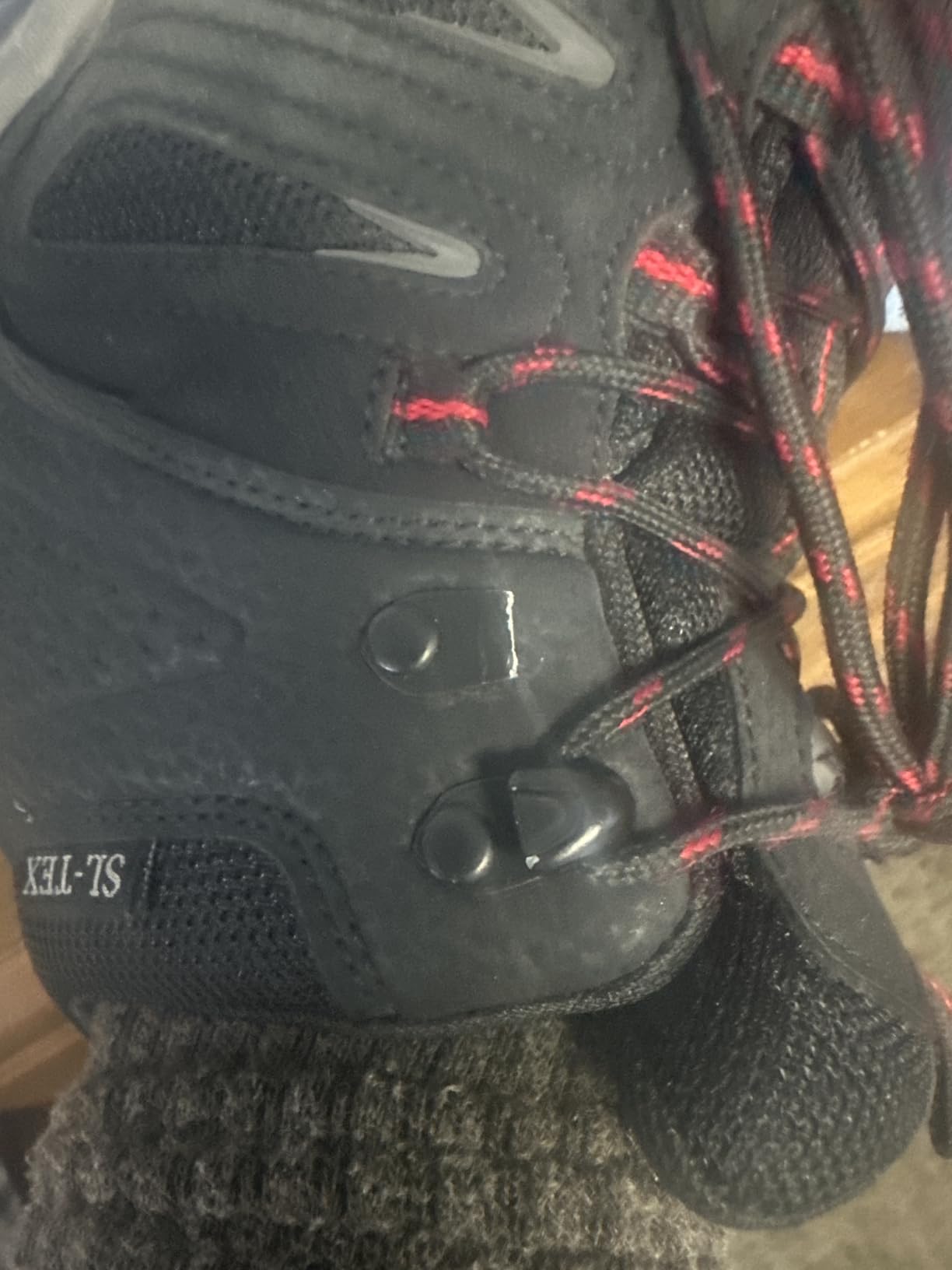 SHULOOK hiking boot close-up showing lace hook construction detail and potential durability concern