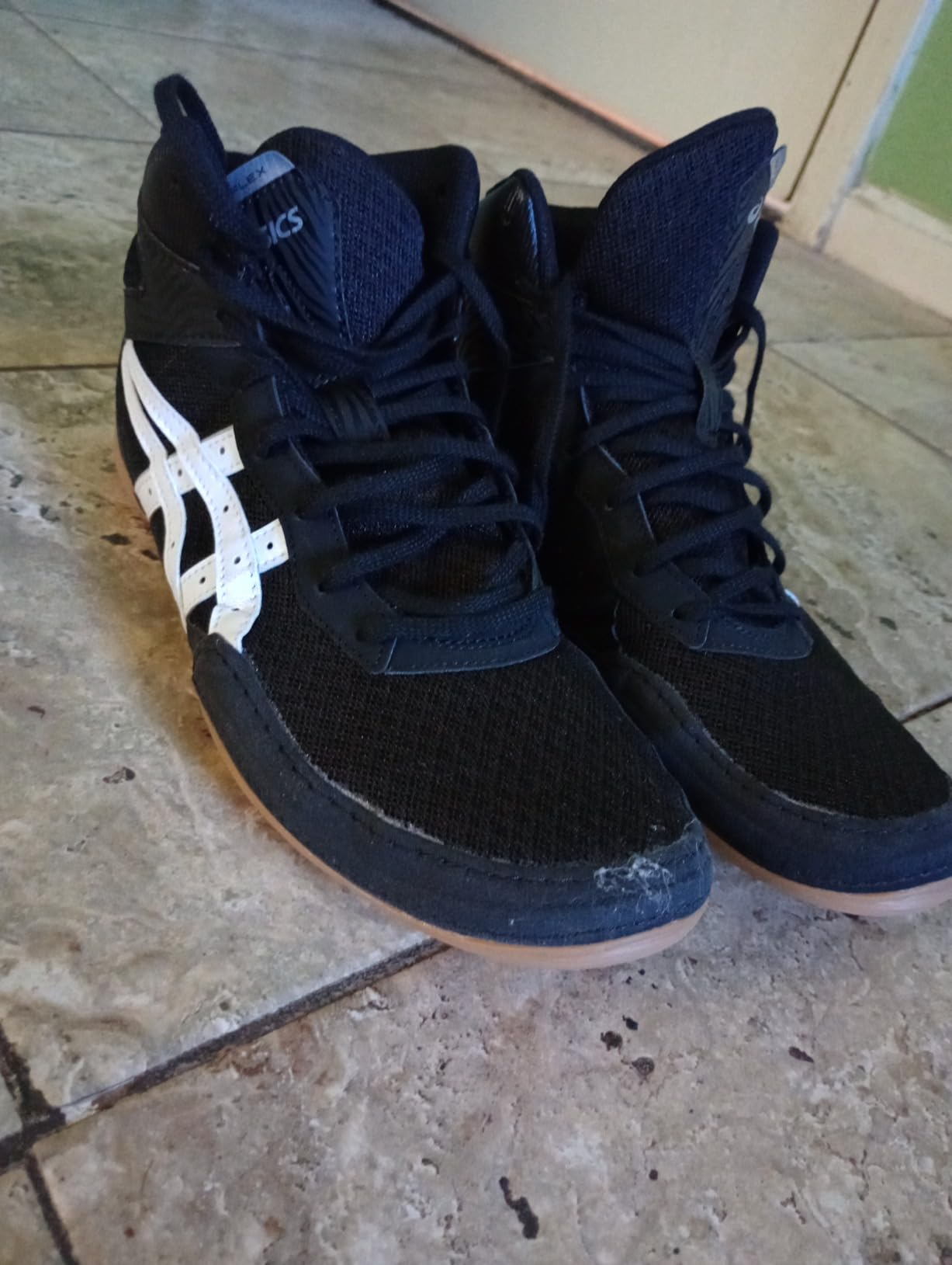 Close-up view of ASICS Matflex 7 lacing system and ankle-high design showing construction quality
