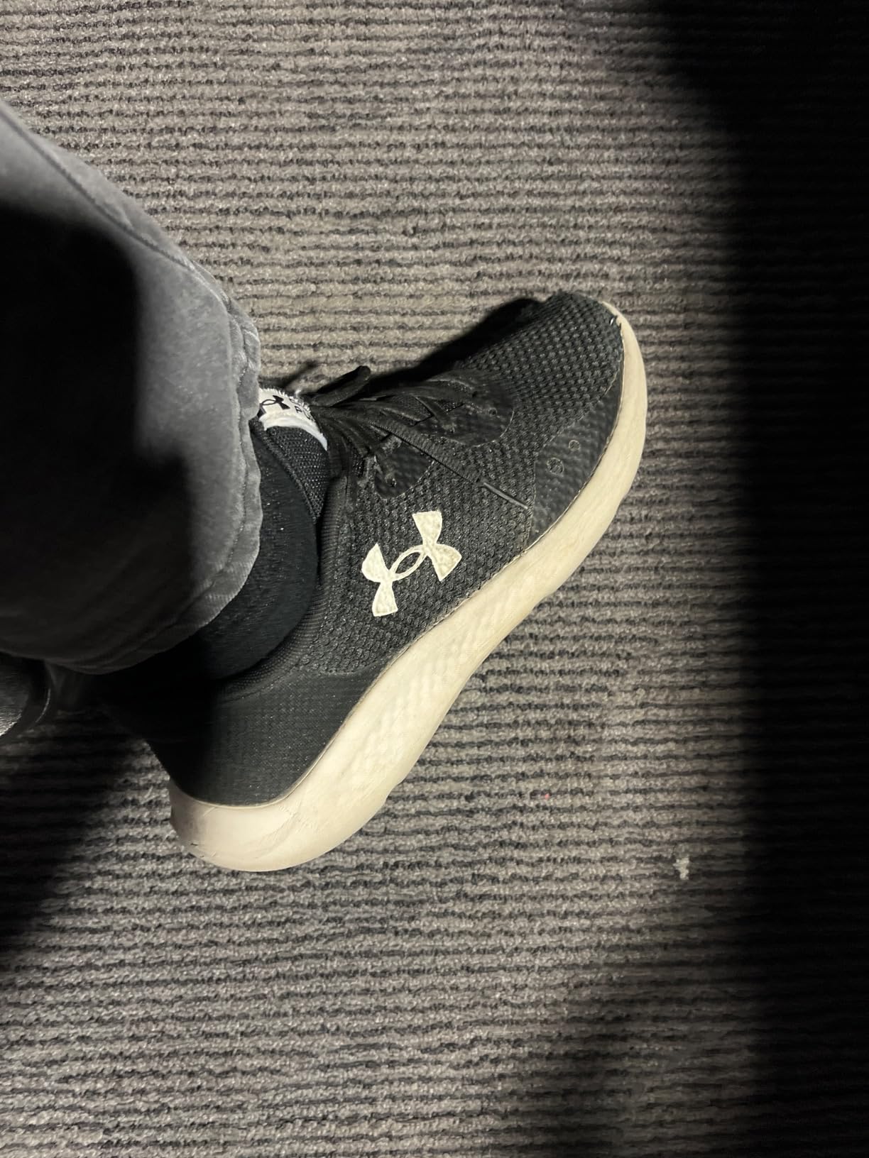 Under Armour Charged Pursuit 3 running shoes showing structured mesh upper and Charged Cushioning midsole