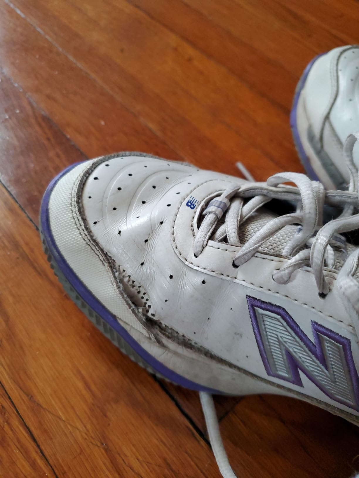 New Balance 806 side profile showing ROLLBAR technology and leather construction details
