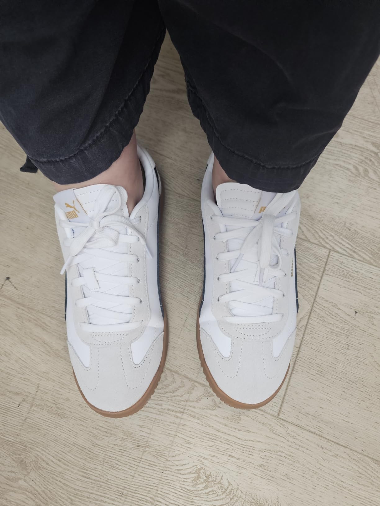 PUMA Club 5v5 close-up showing coated leather upper with soccer-inspired stitching detail and gold foil branding