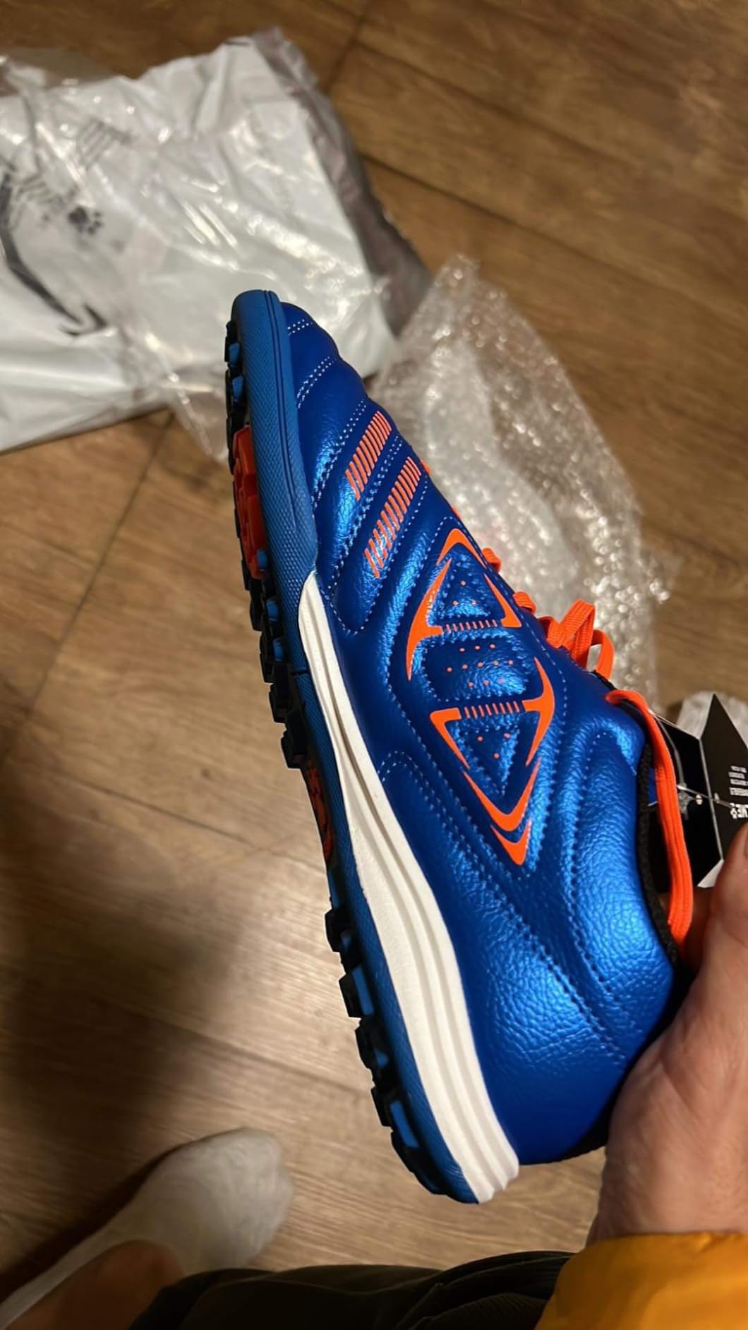 Multiple angle view of KELME soccer cleats showing triangular TF stud pattern configuration and rubber outsole design