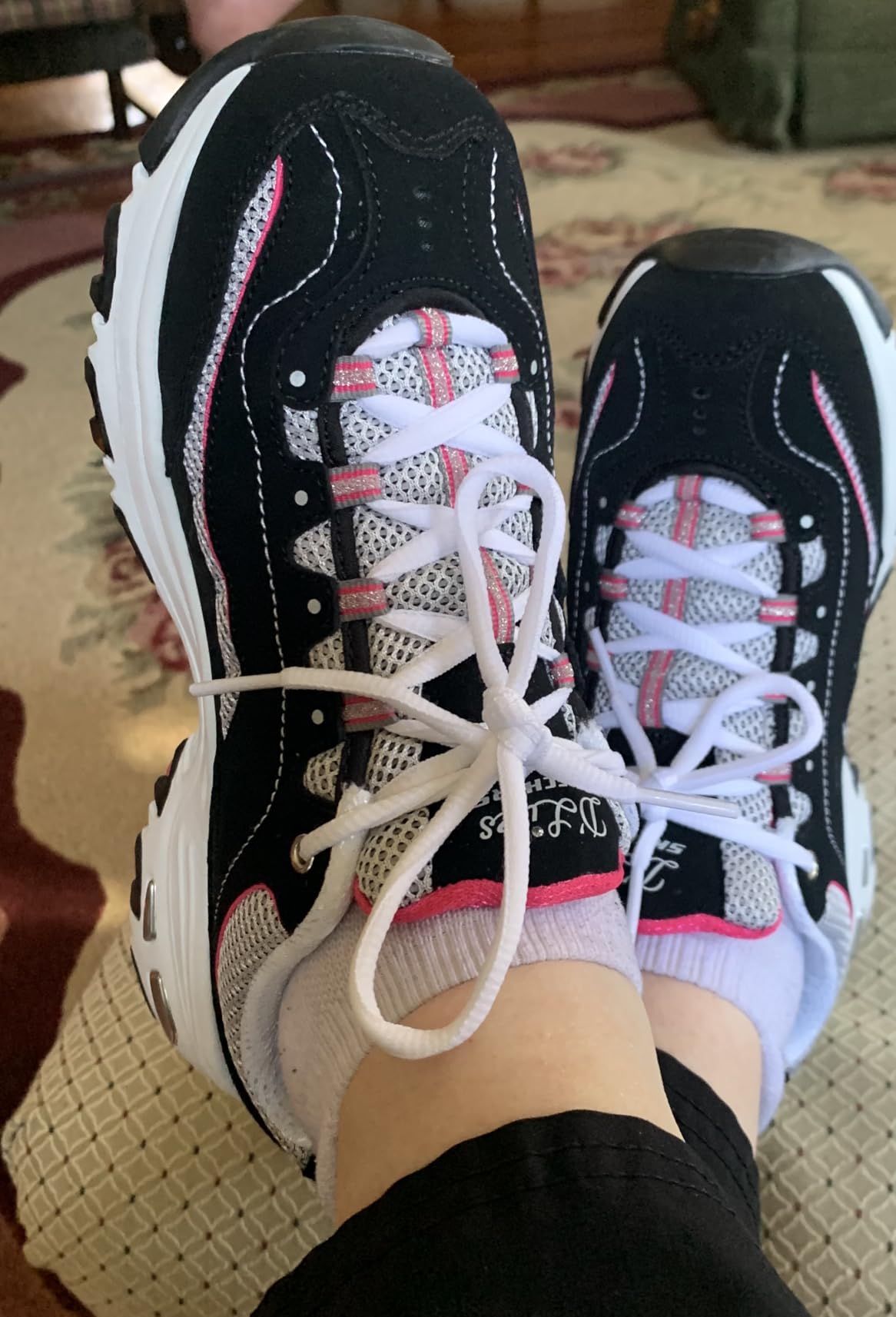 Customer wearing their Skechers D'Lites in an everyday setting, looking comfortable and happy with the shoe.