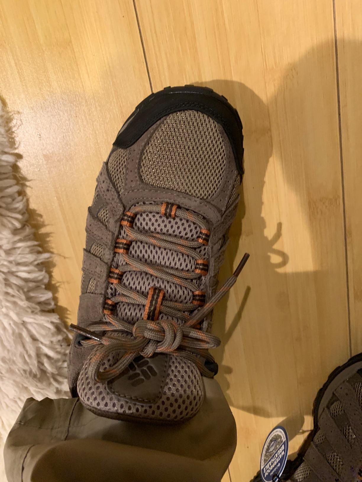 Action shot of Columbia Redmond Waterproof hiking shoes on wet trail demonstrating real-world traction and waterproofing