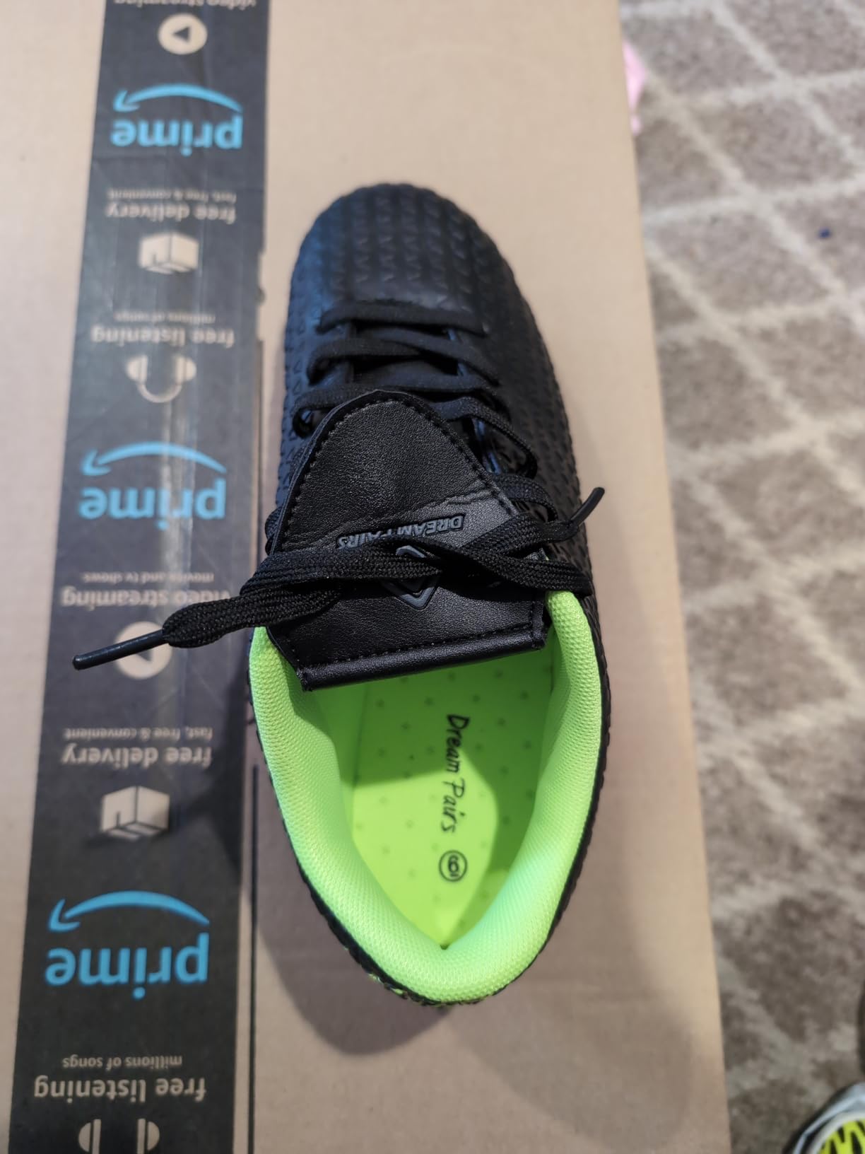 DREAM PAIRS soccer cleats upper construction showing faux leather material quality and lacing system detail