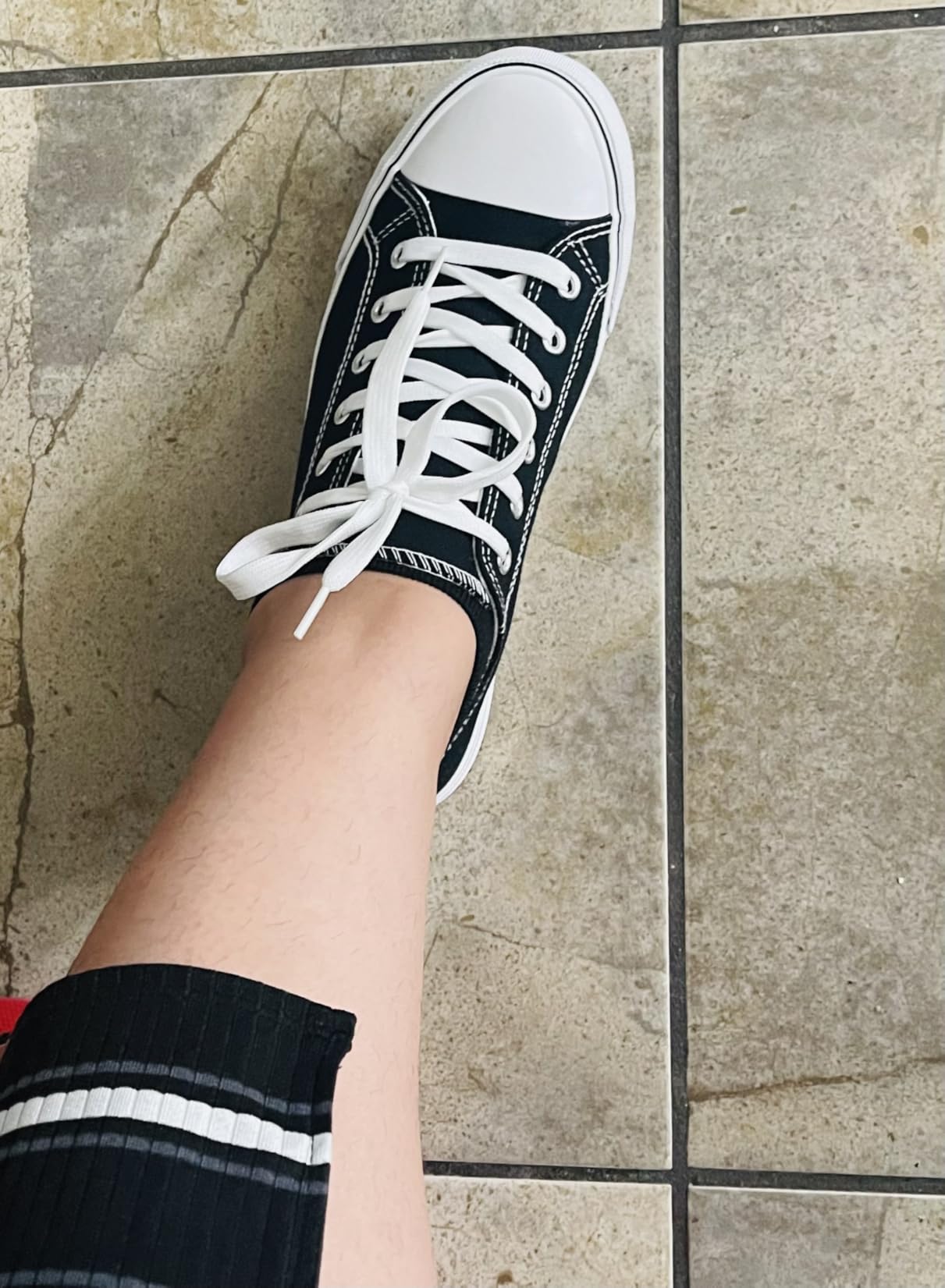 Real customer wearing Adokoo canvas sneakers showing authentic everyday usage