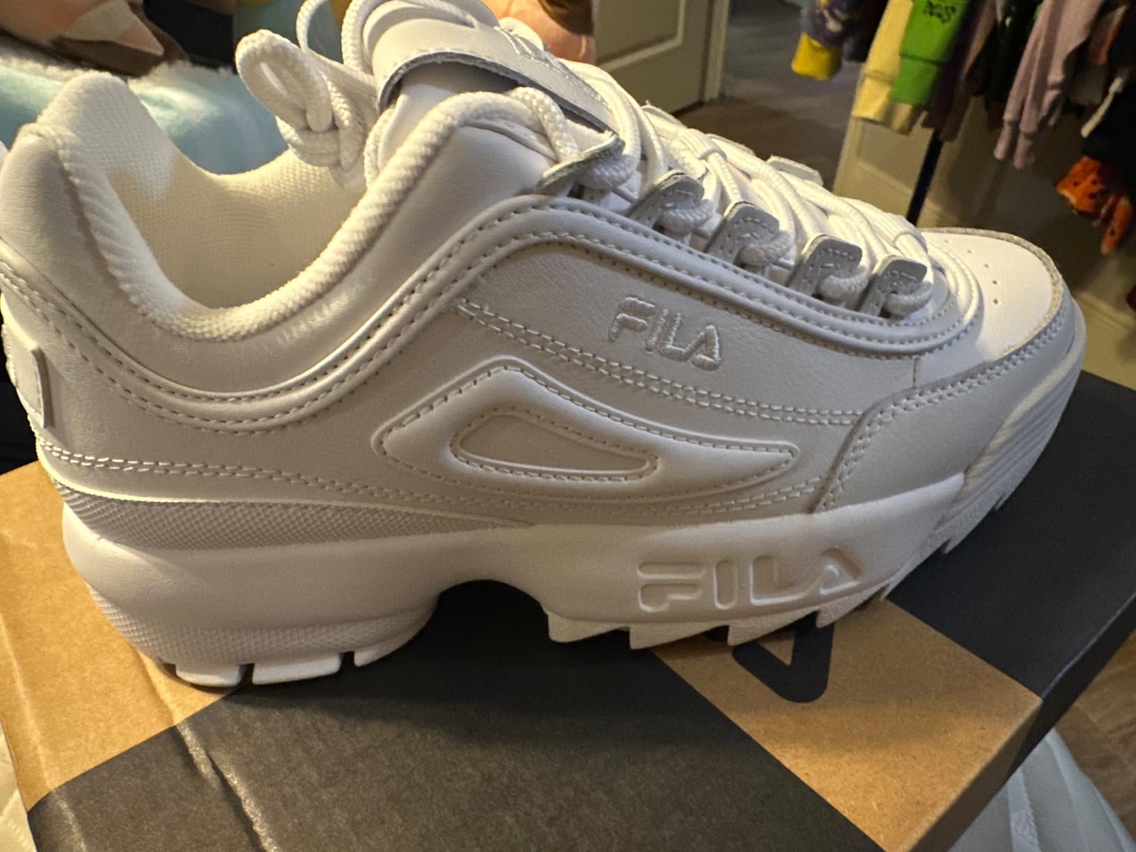 Fila Disruptor II shown in casual lifestyle wearing scenario demonstrating everyday versatility and style integration