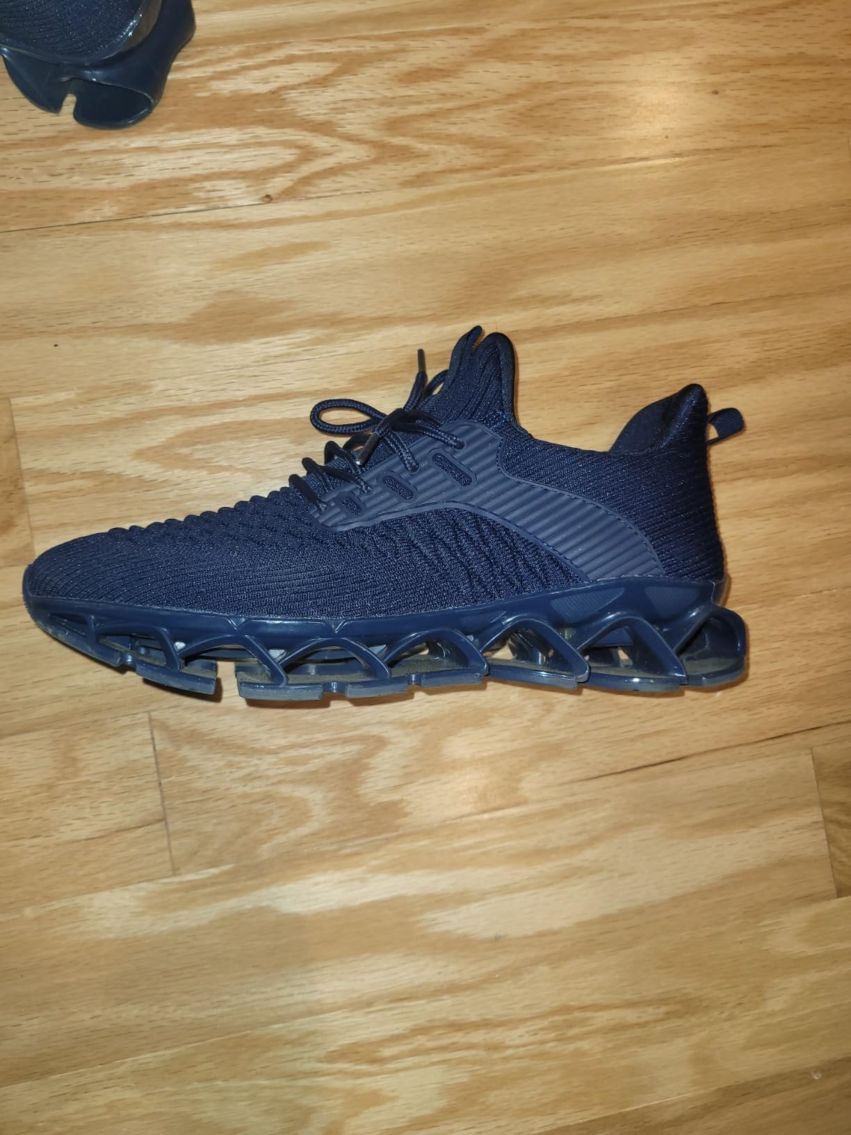 Srenket blade sneakers shown from a side ankle perspective highlighting the lattice sole profile during wear testing
