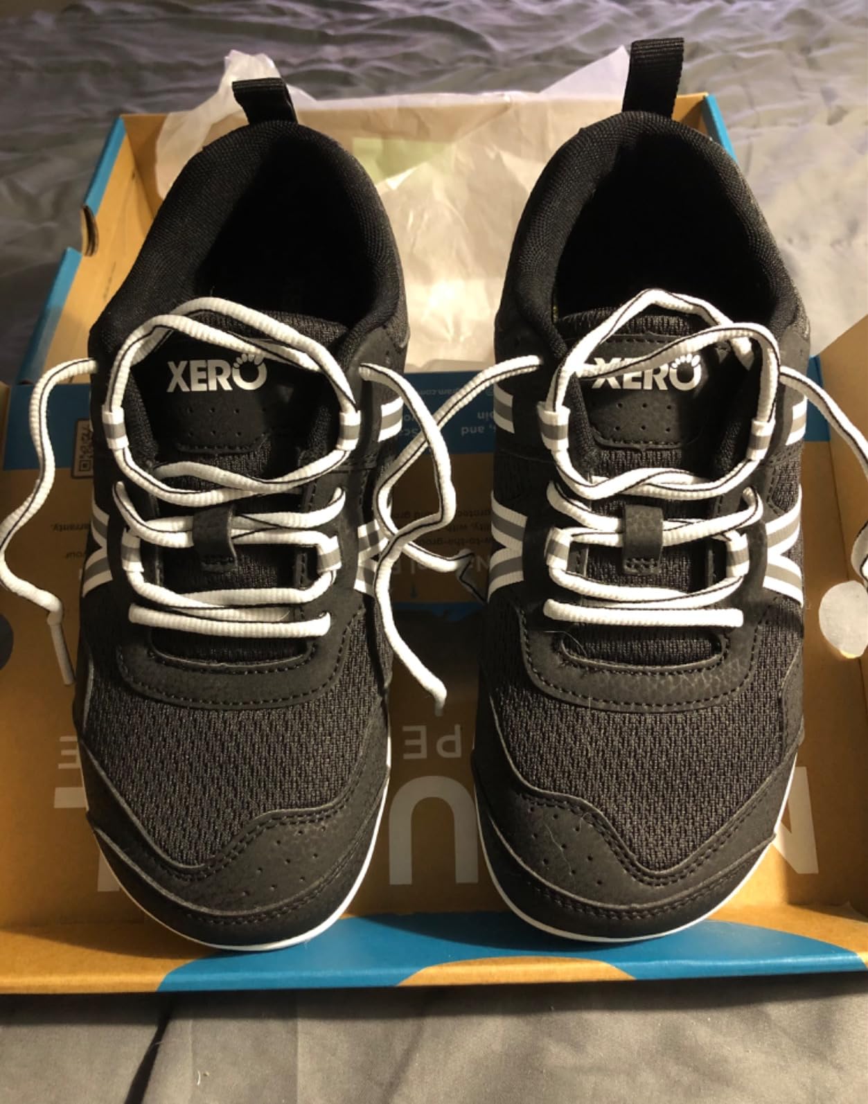 Xero Prio lacing system detail showing heel strap and instep strap design for customizable secure fit
