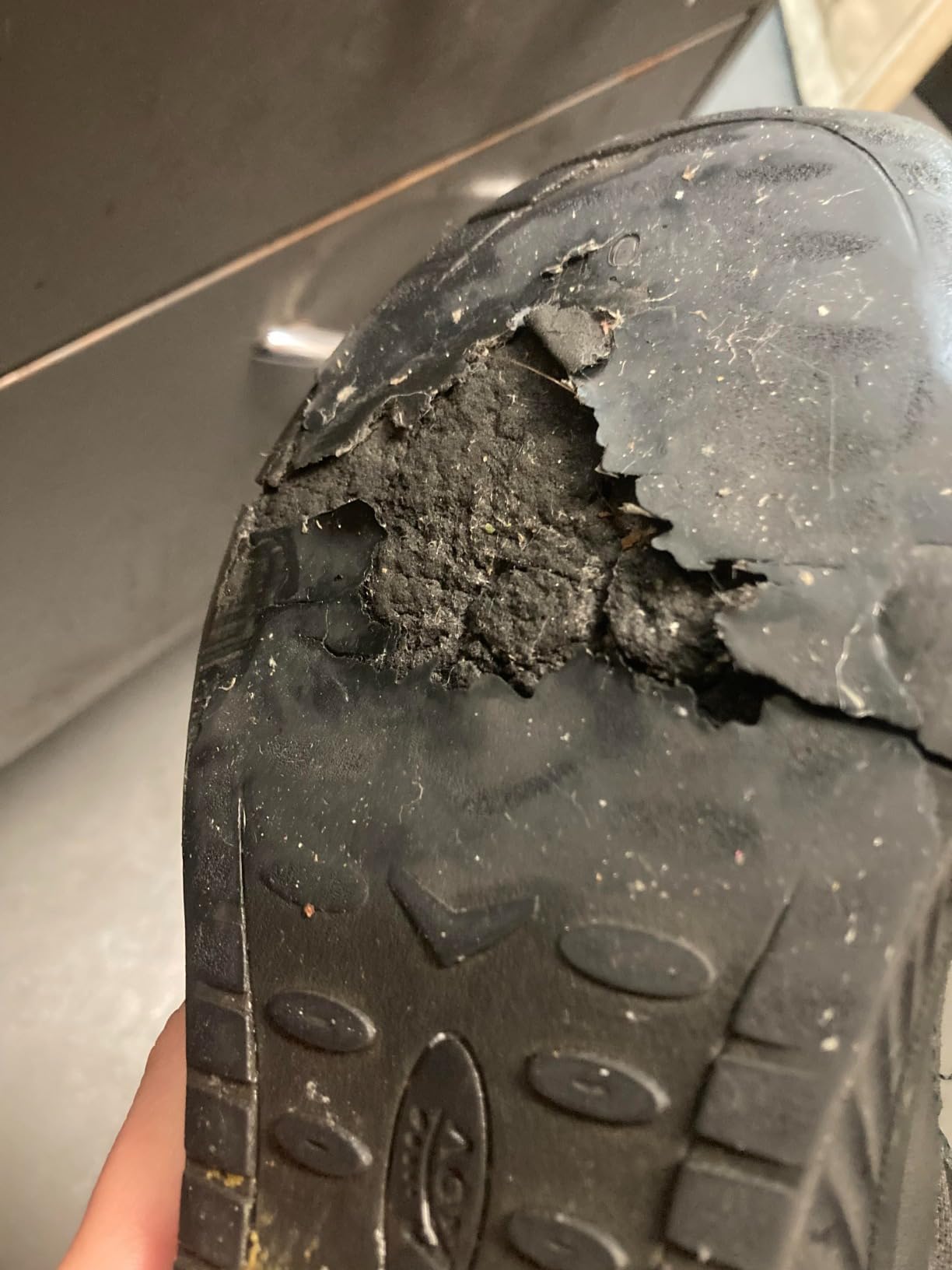 Close-up of AOV shoe insole construction showing arch support attachment and orthotic footbed detail