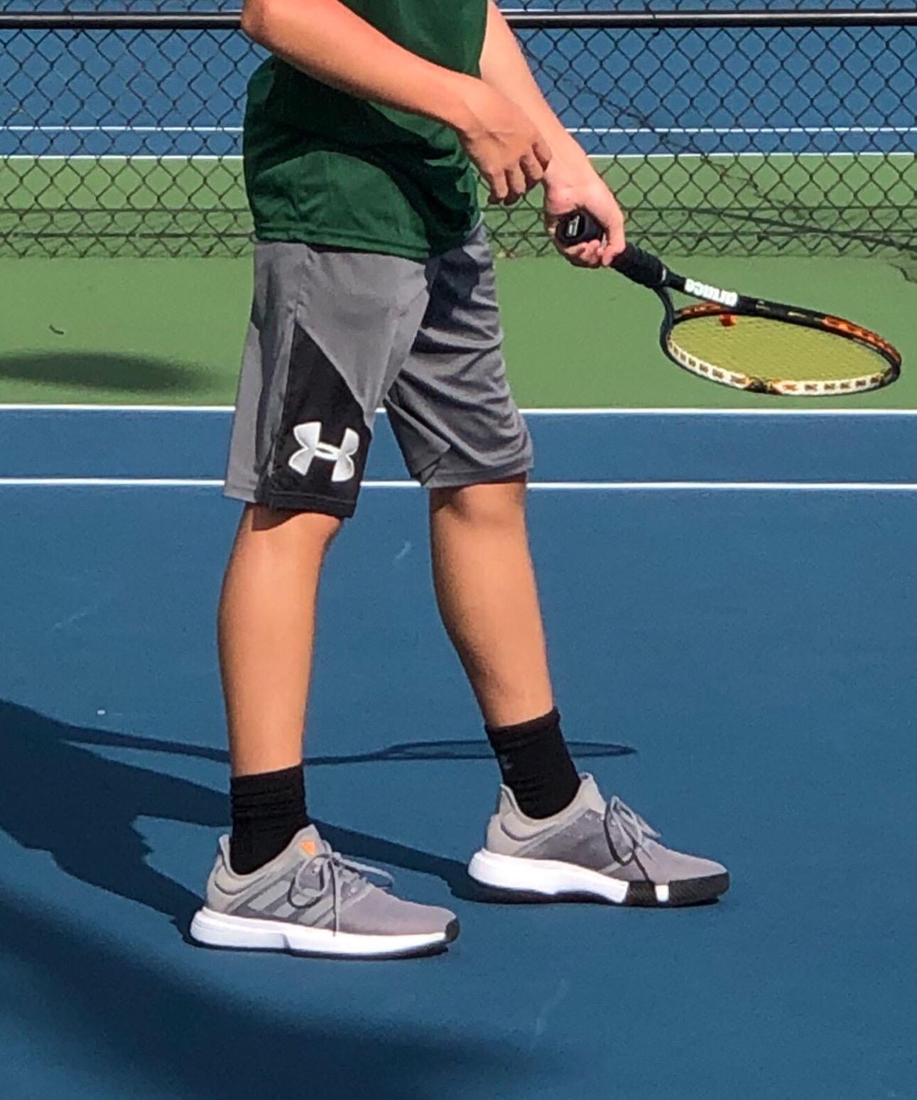 Tennis player wearing Adidas Gamecourt M showing positive real-world reception among recreational players