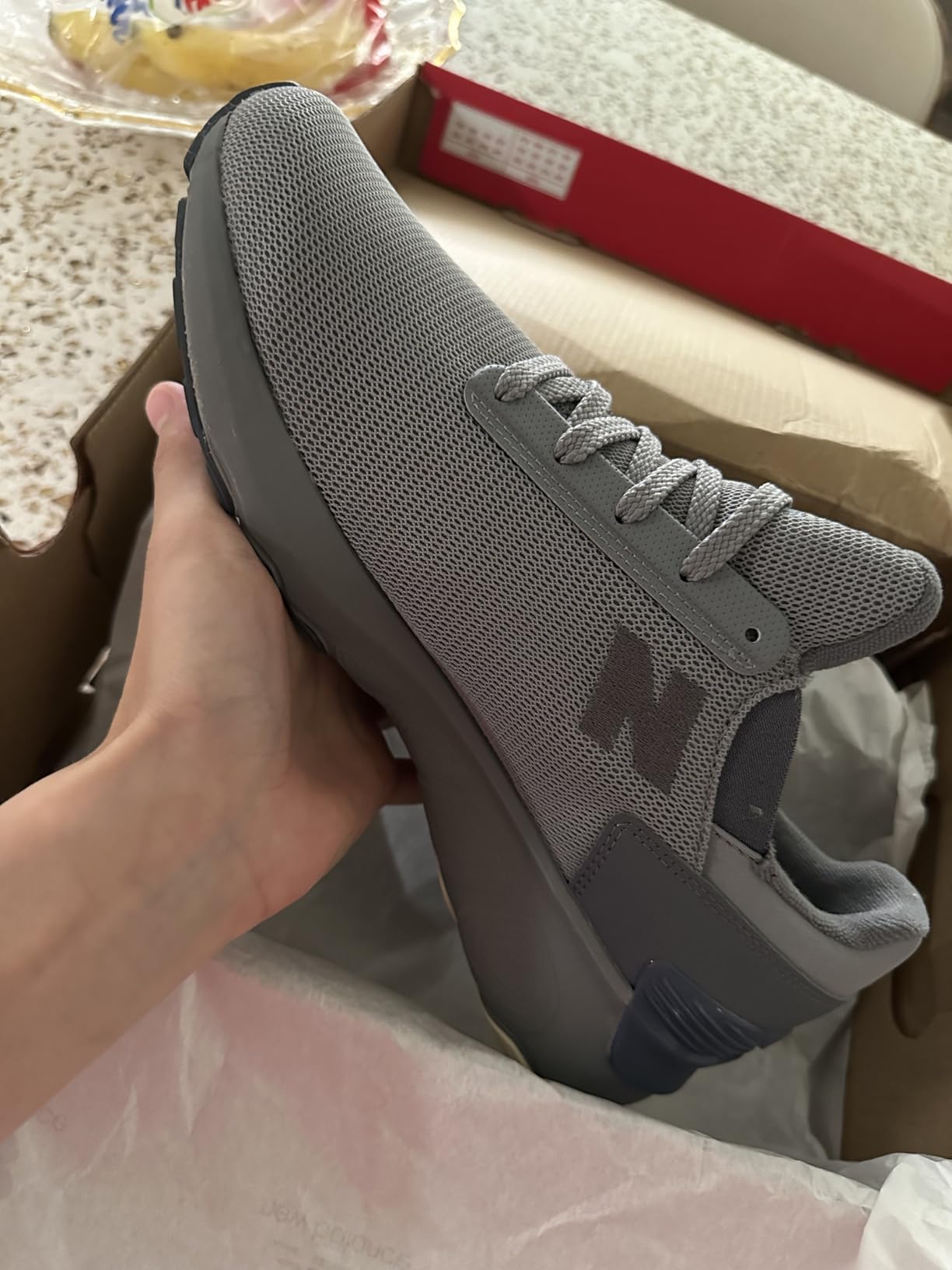New Balance 1440 V1 side profile detail showing knit mesh upper construction and TPU heel clip