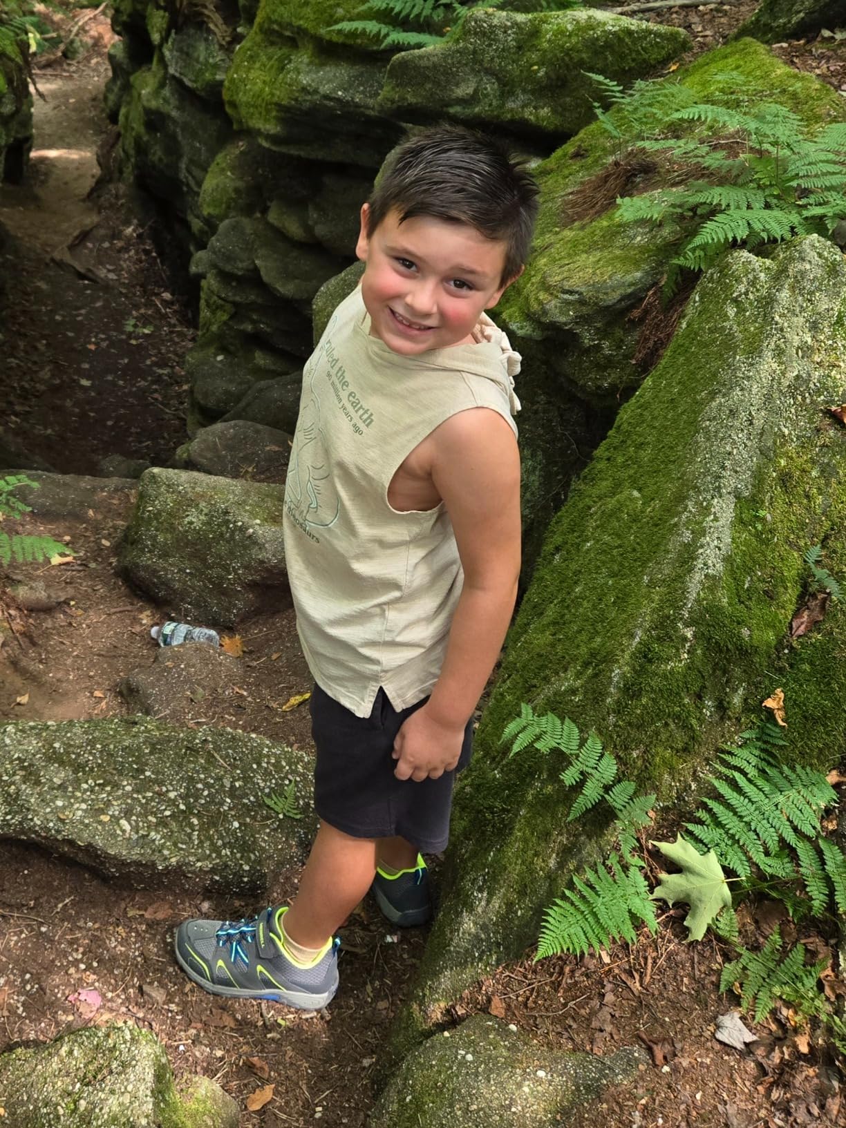 Child wearing Merrell Trail Chaser 2 Jr hiking on rocky terrain showing real-world trail traction performance