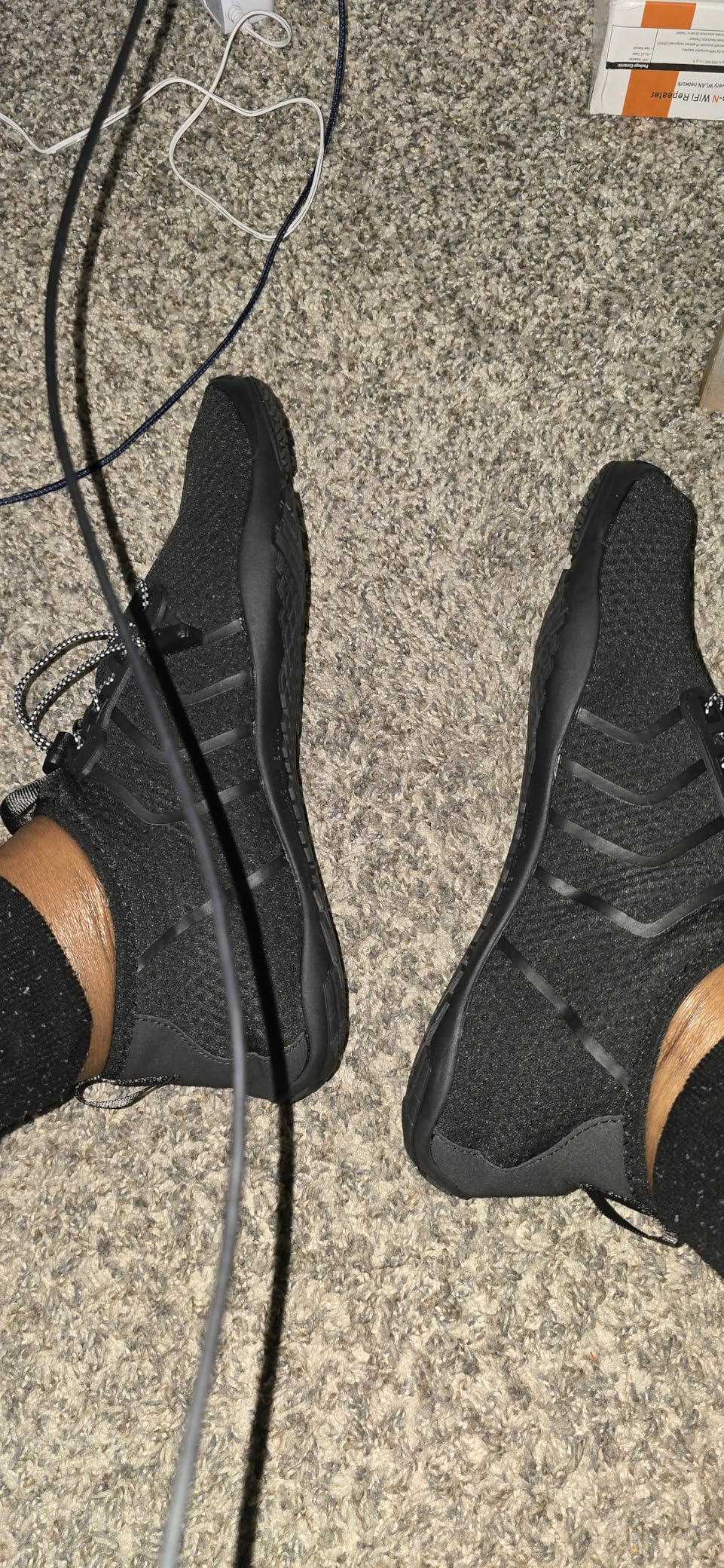 Racqua water shoes drainage system showing strategic sole holes and flexible construction during water activities