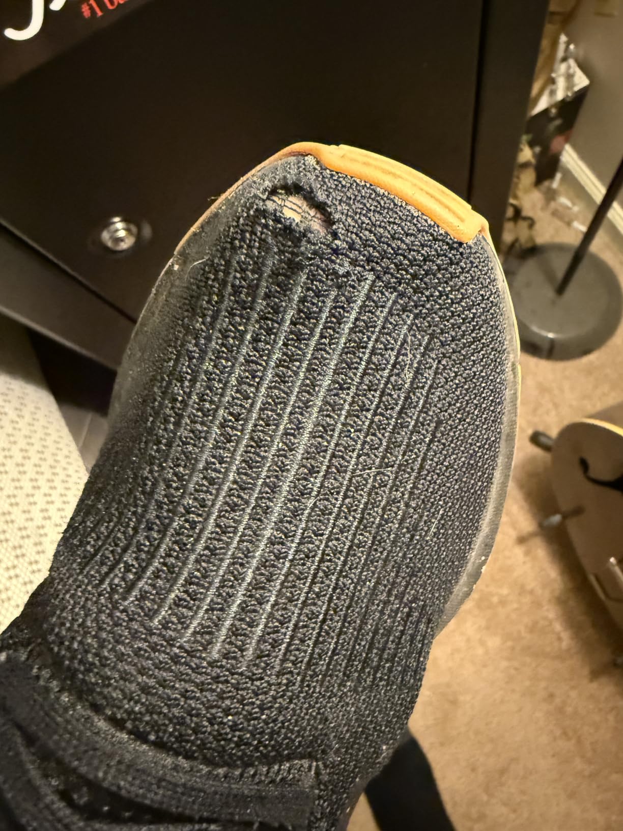Close-up of Adidas Swift Run knit upper texture and lacing system showing sock-like construction detail