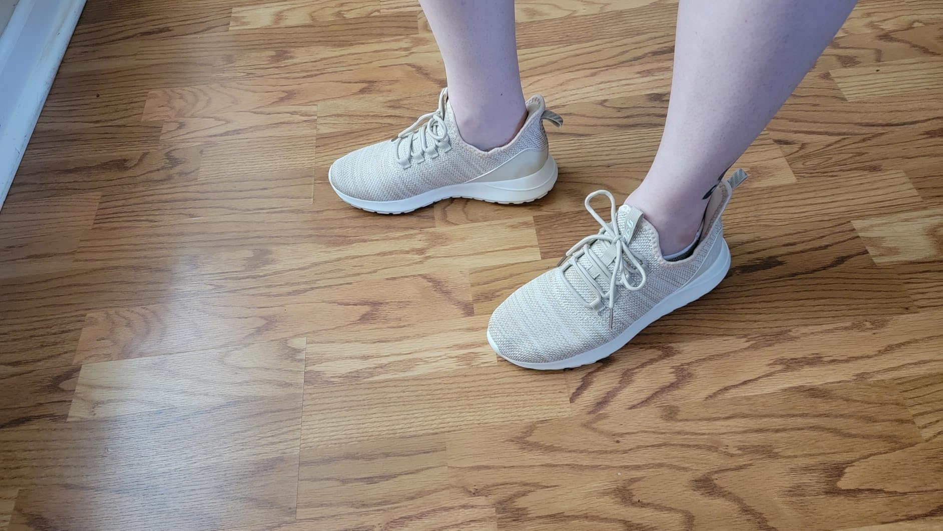 STQ women's sneakers side profile showing flexible heel collar and slip-on entry mechanism