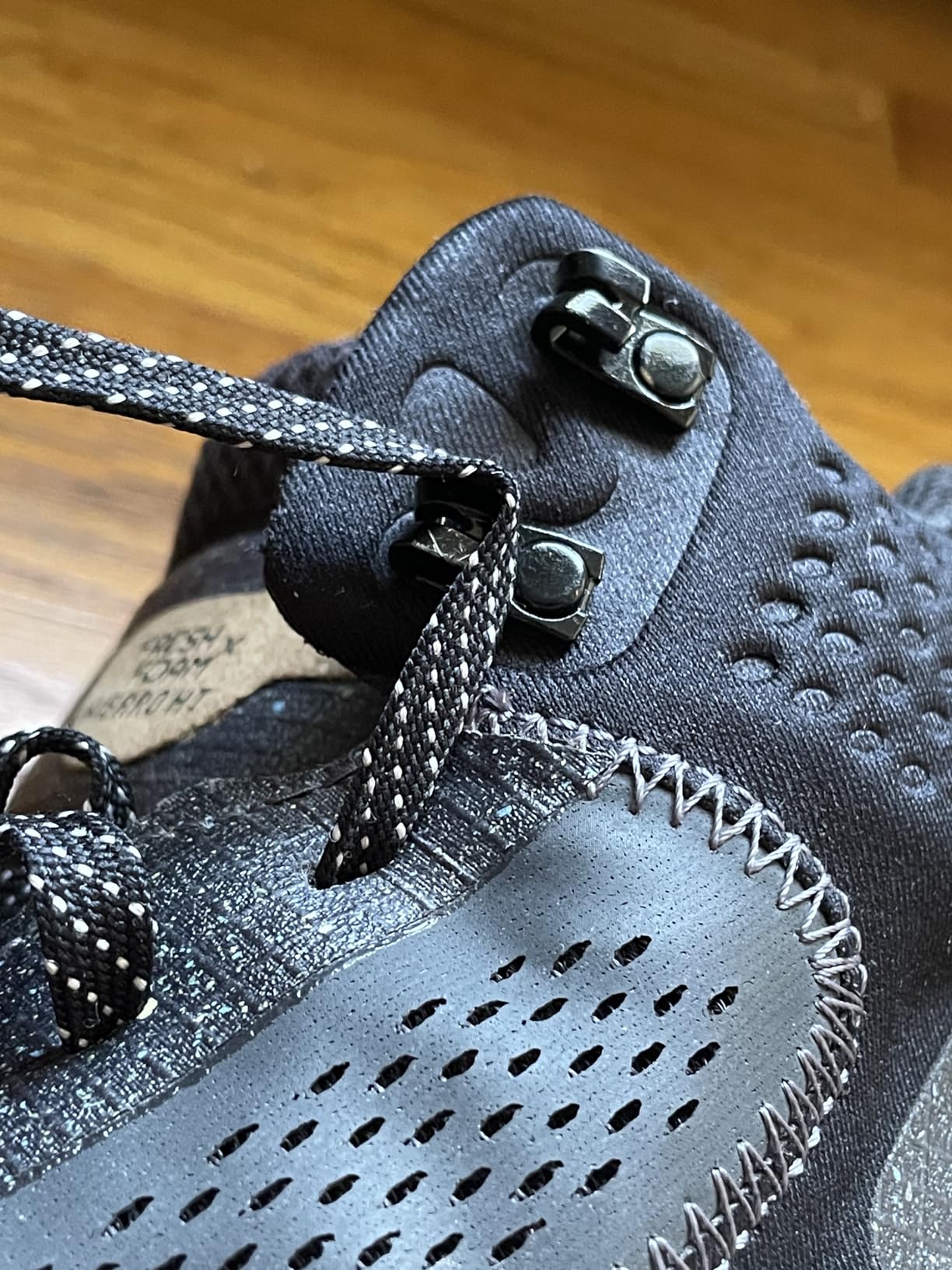 Side view showing mid-cut ankle collar and lacing system with metal hooks on the New Balance Hierro Mid