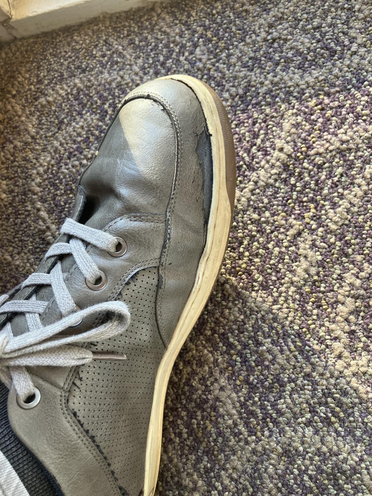 Close-up showing sole separation issue at the junction between rubber sole and synthetic leather upper
