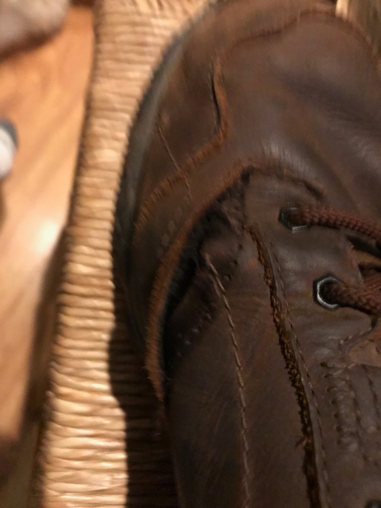 Close-up showing early signs of toe guard separation on Merrell Moab Adventure Lace after extended wear