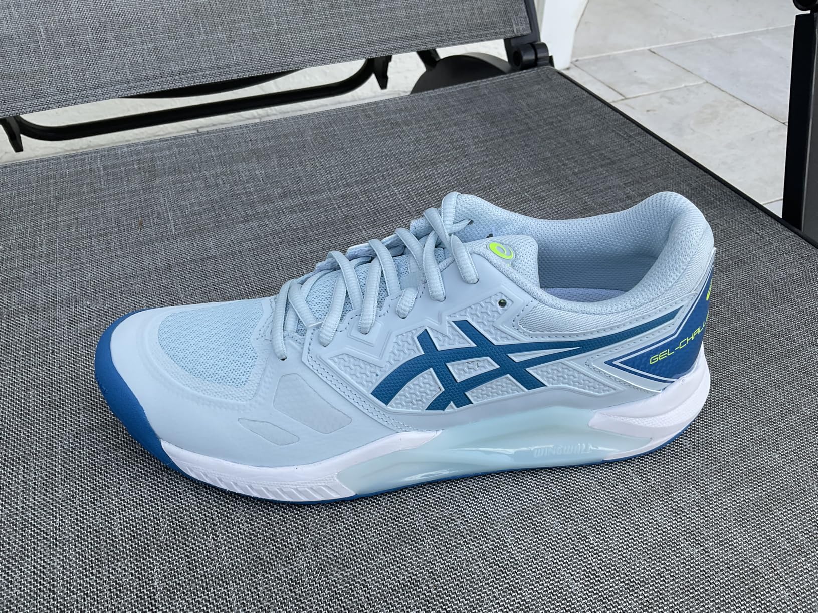 ASICS Gel-Challenger 13 in action during lateral movement on tennis court showing stability performance