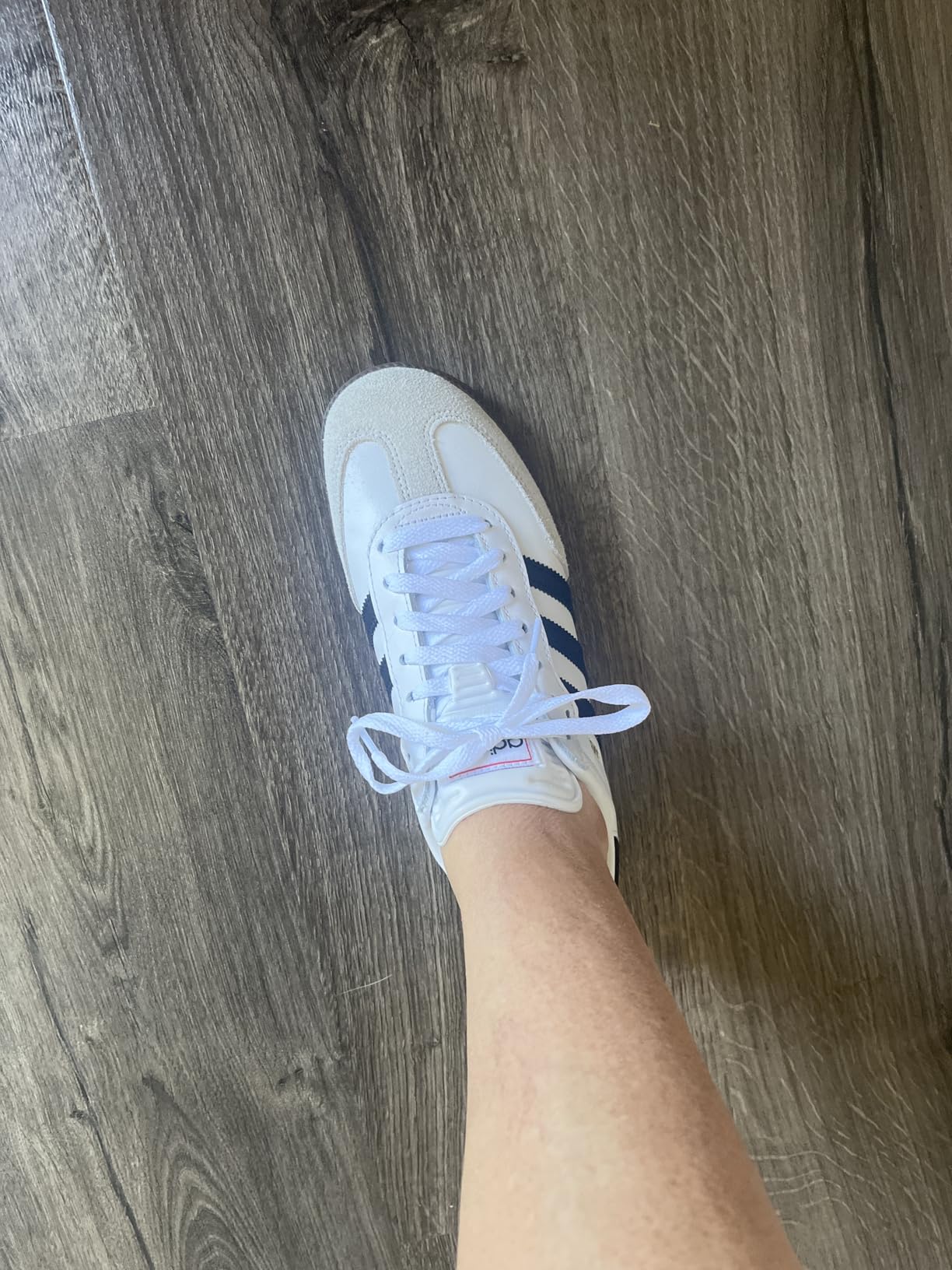 Adidas Samba kids sneaker detail showing leather upper construction, suede overlays, and three stripes branding