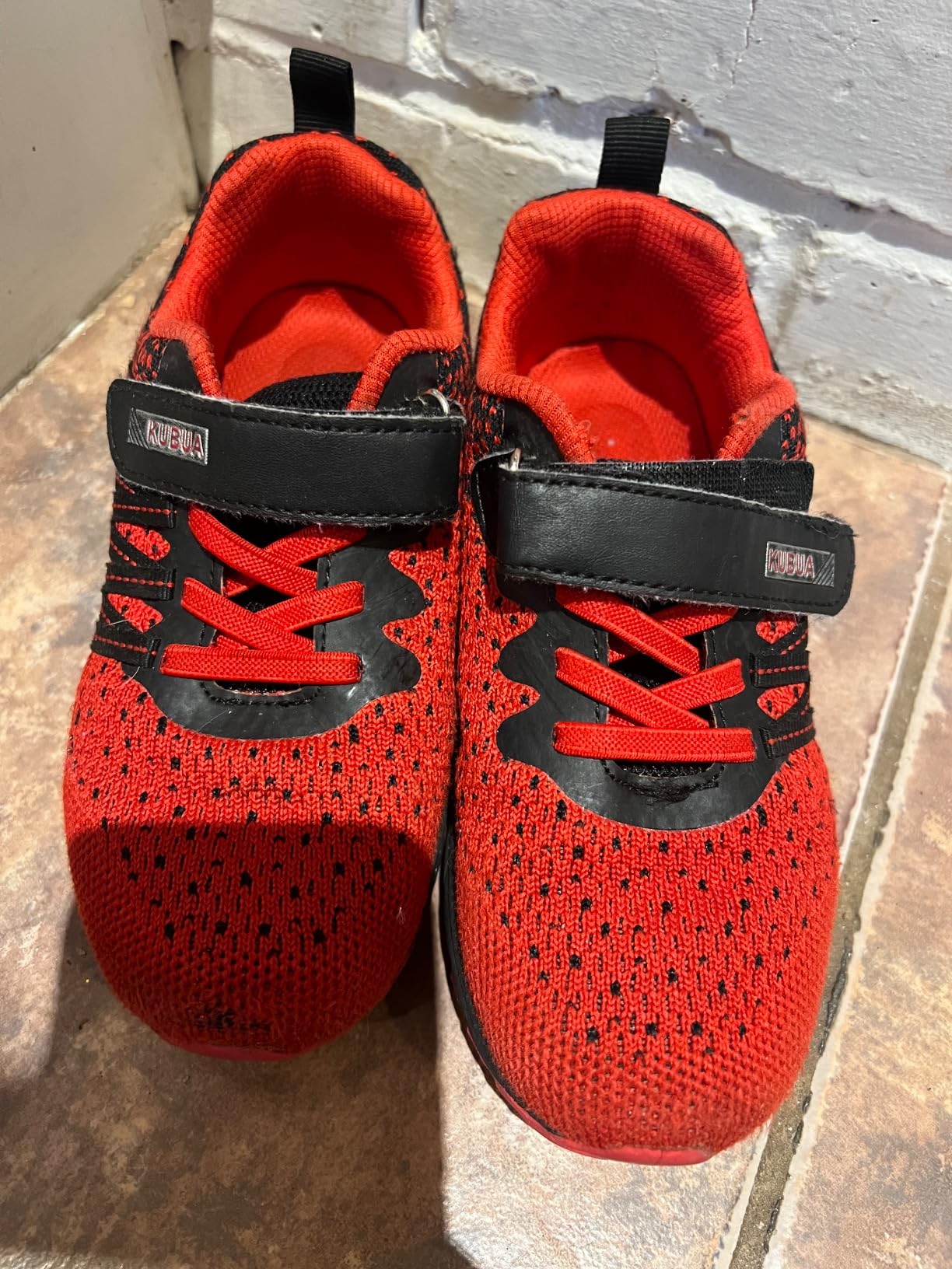 Close-up of KUBUA Kids Sneakers showing hook and loop Velcro closure system and padded collar