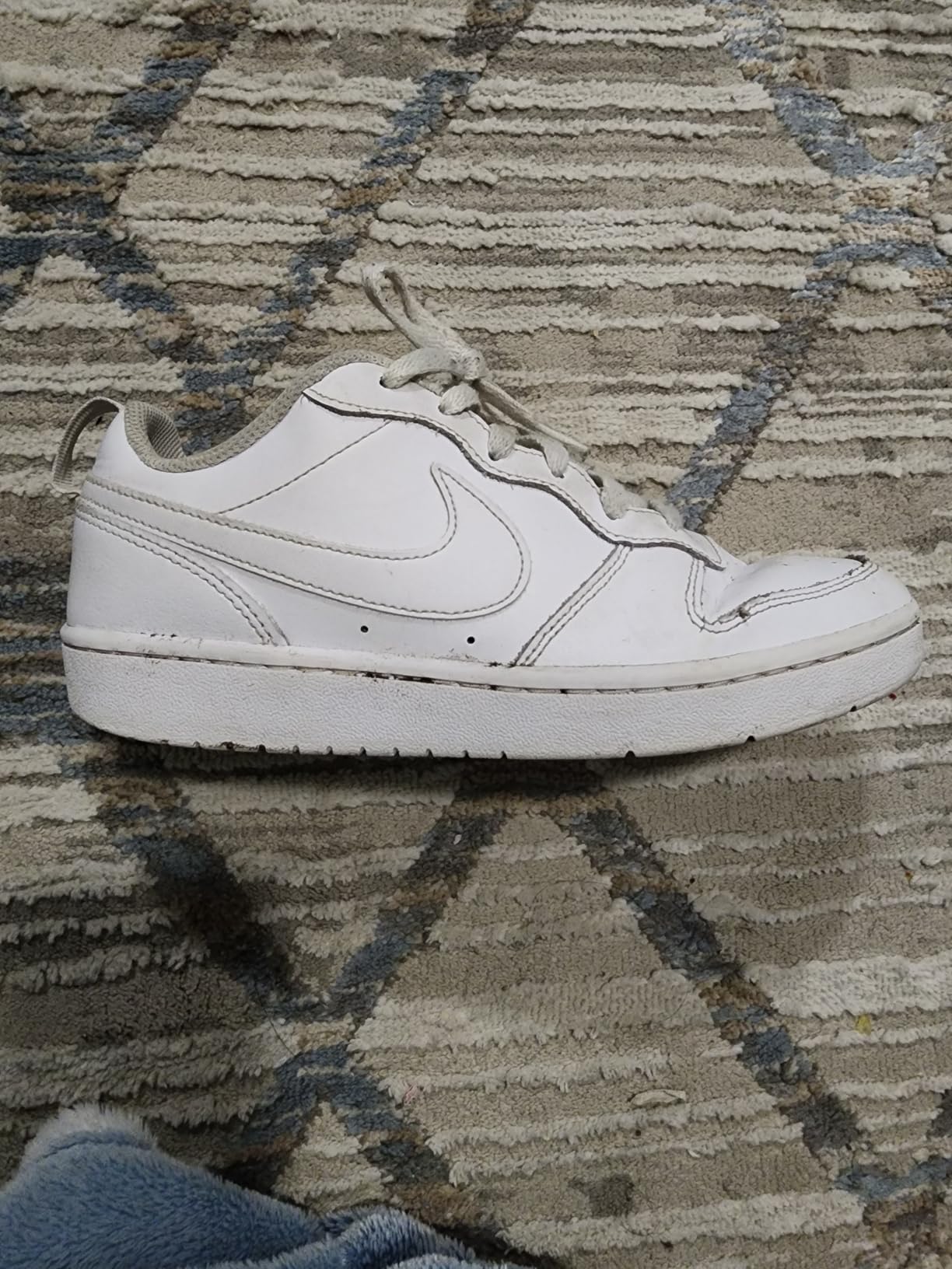 Detailed view of sole wear pattern on Nike Court Borough Low showing high-wear areas after daily use