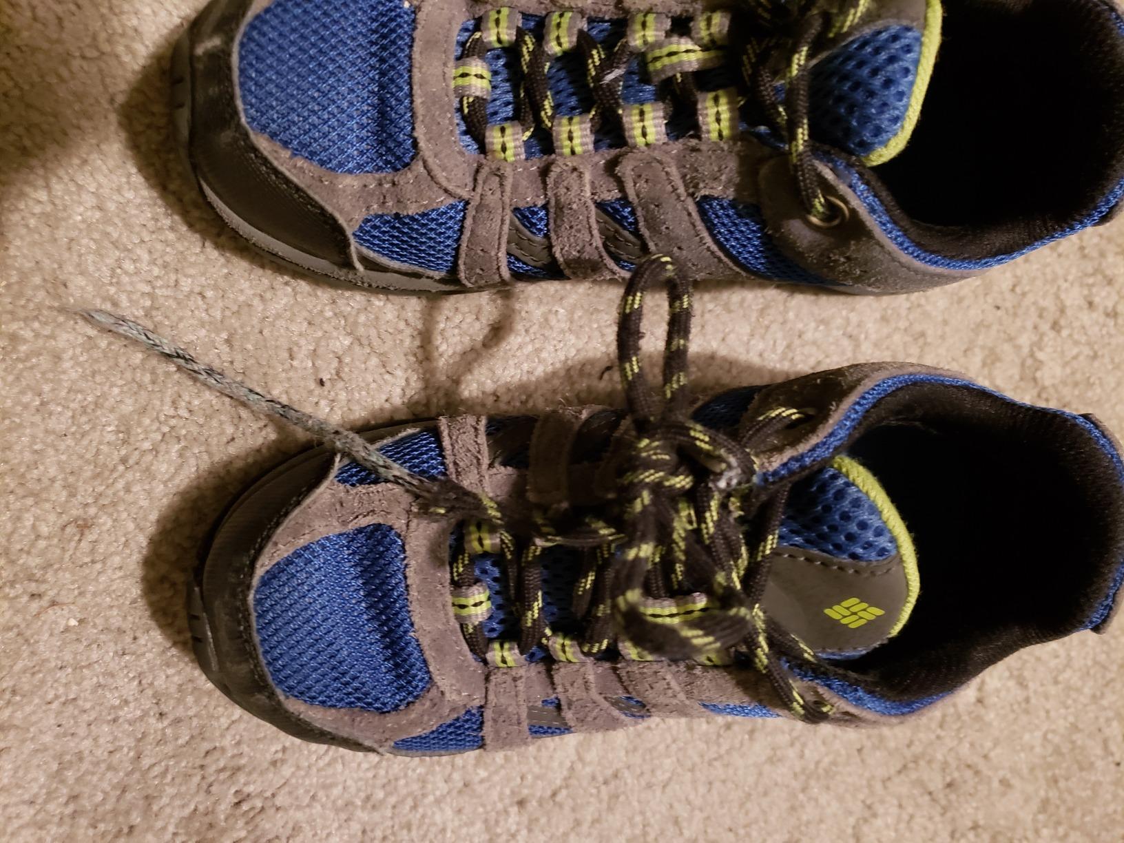 Columbia Redmond kids hiking shoe showing reinforced toe cap construction and suede leather upper detail