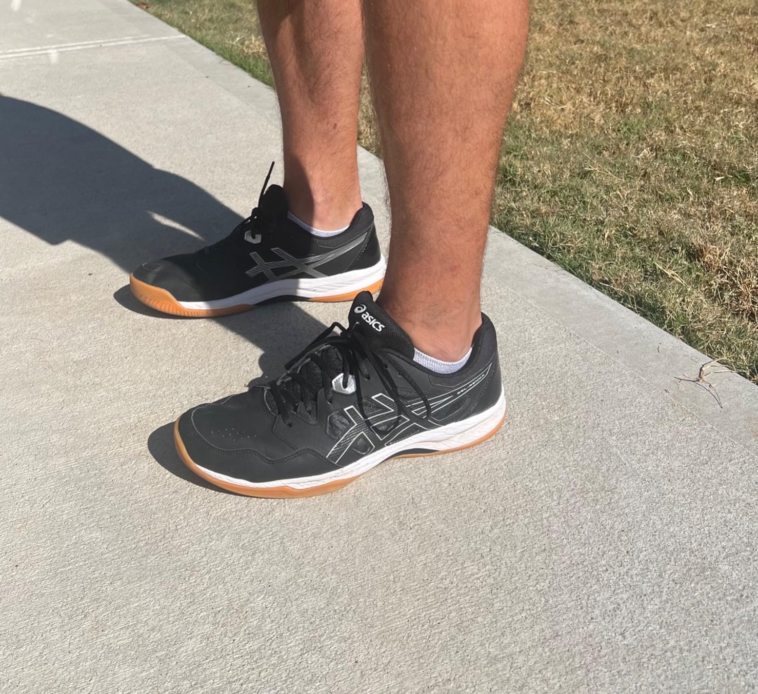 Side profile of ASICS Gel-RENMA highlighting wrap-up outsole design and flex grooves for court movement