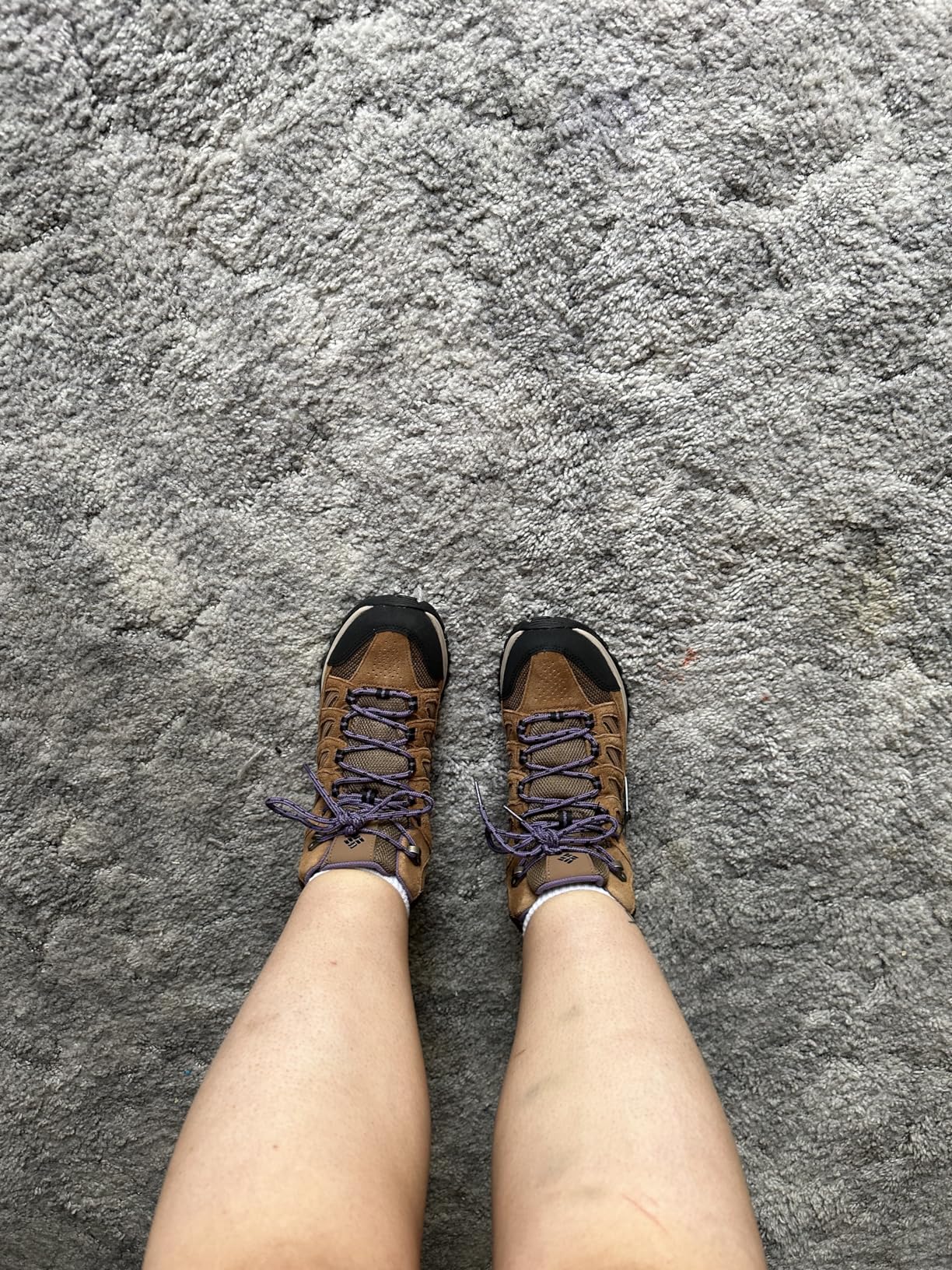 Columbia Crestwood boots in action on rocky hiking trail showing traction pattern and ankle support
