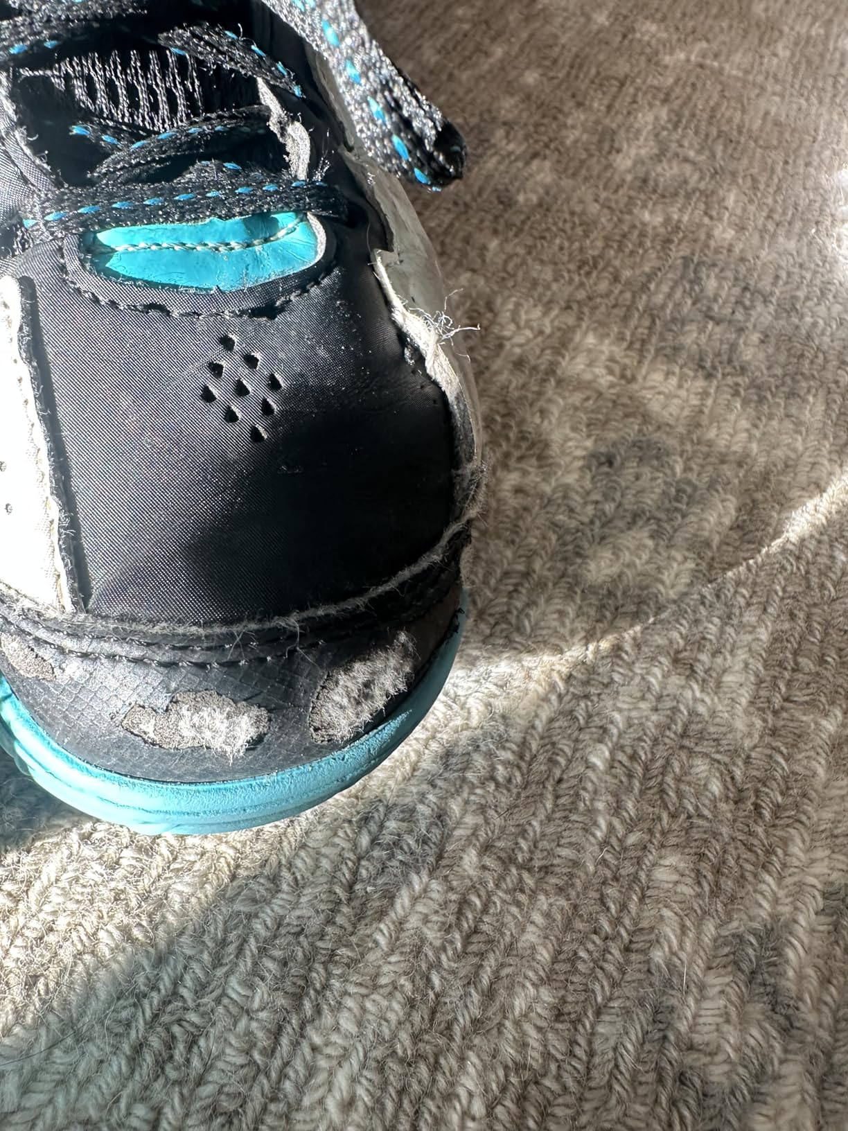 Side profile of AND1 Showout youth basketball shoe showing high ankle collar height and heel pull tab design
