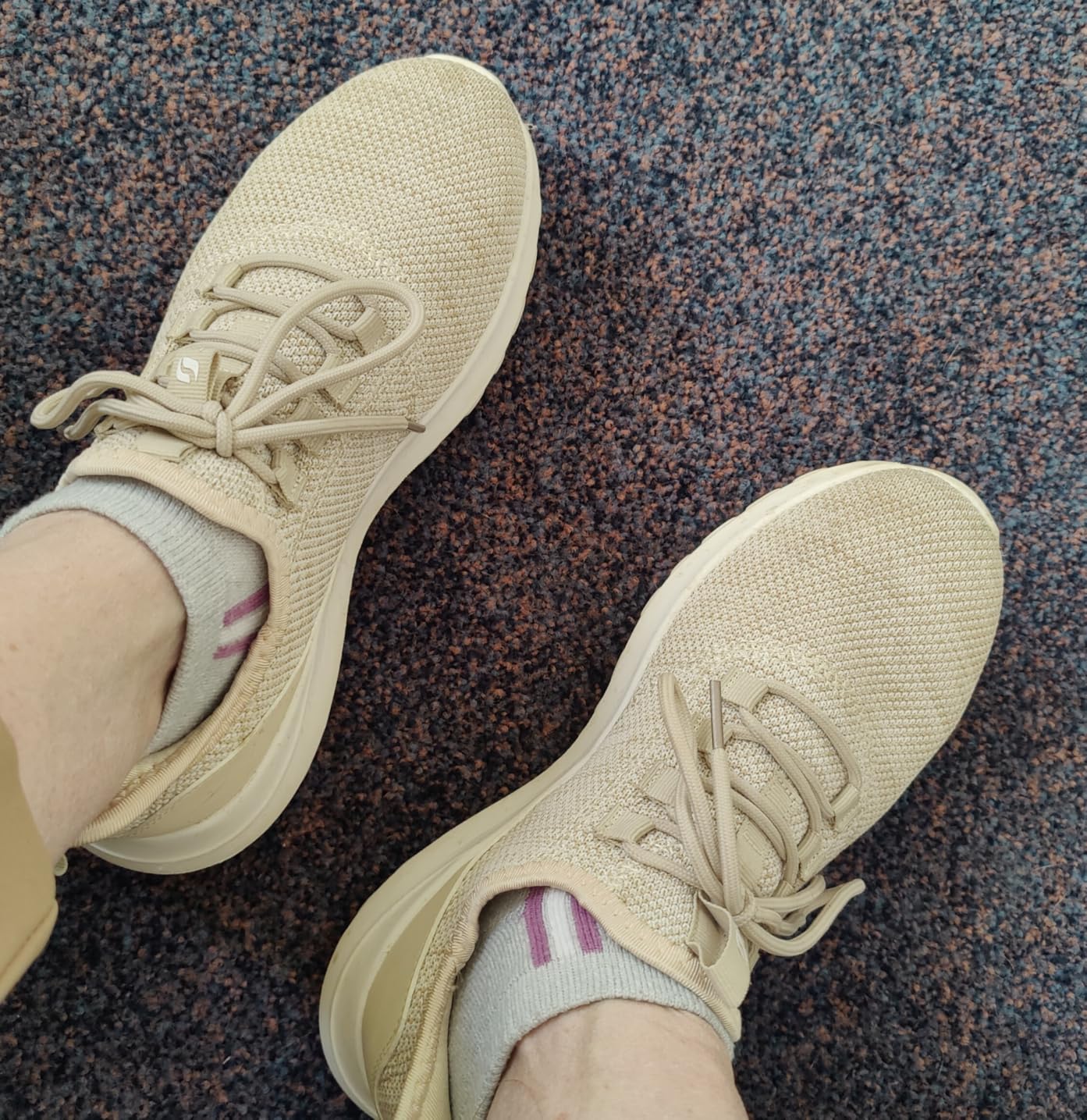 STQ women's sneakers showing sole tread pattern and flexibility during walking
