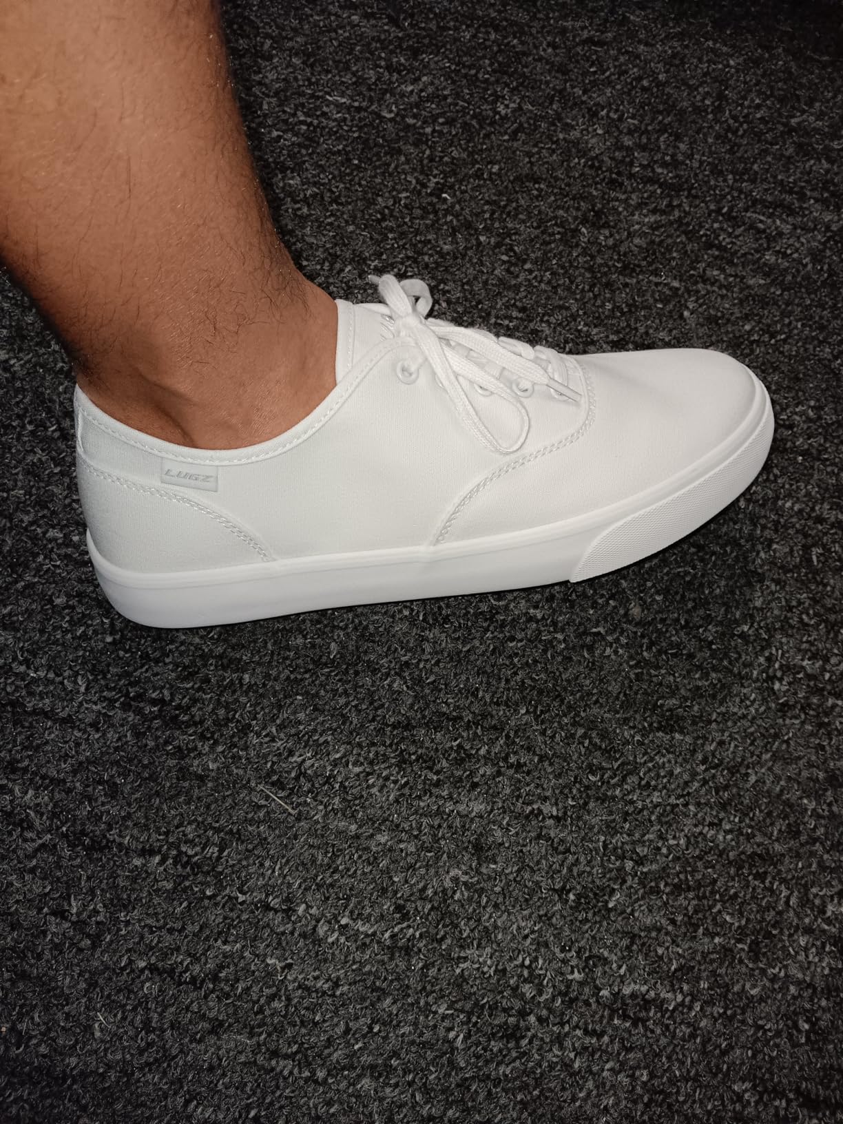 Lugz Men's Lear Sneaker black canvas with white rubber sole and lace-up design on white background