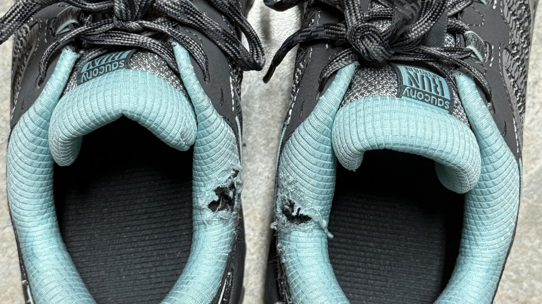 Close-up showing fabric durability issues around ankle collar area of Saucony TR13