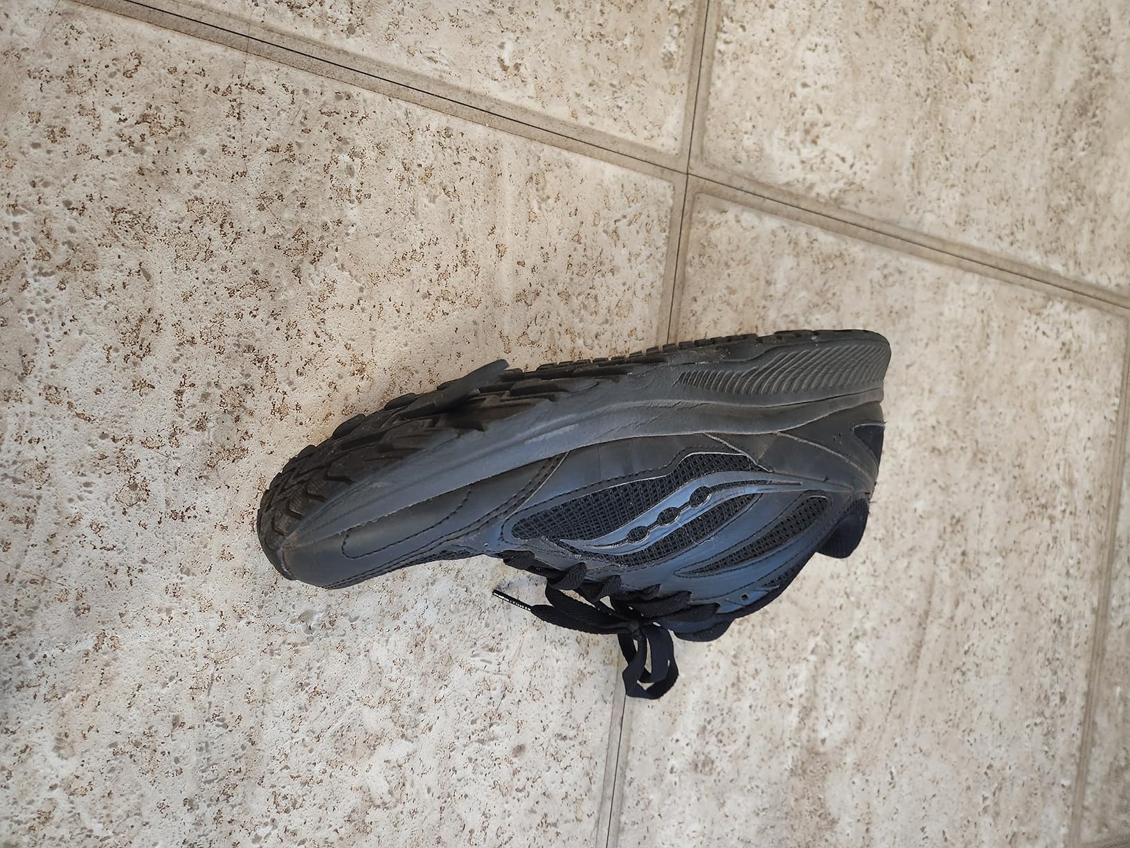Saucony Cohesion 14 TR in action on rocky terrain showing grip and stability performance